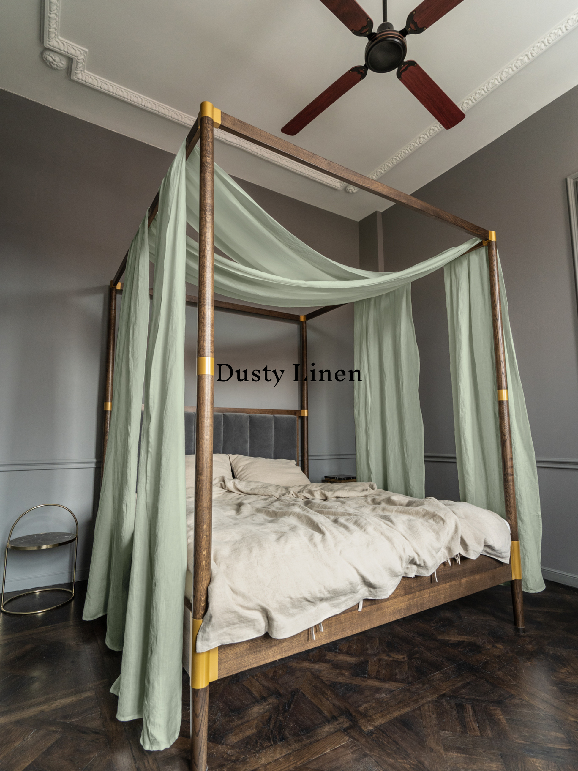 a four poster bed with a green canopy