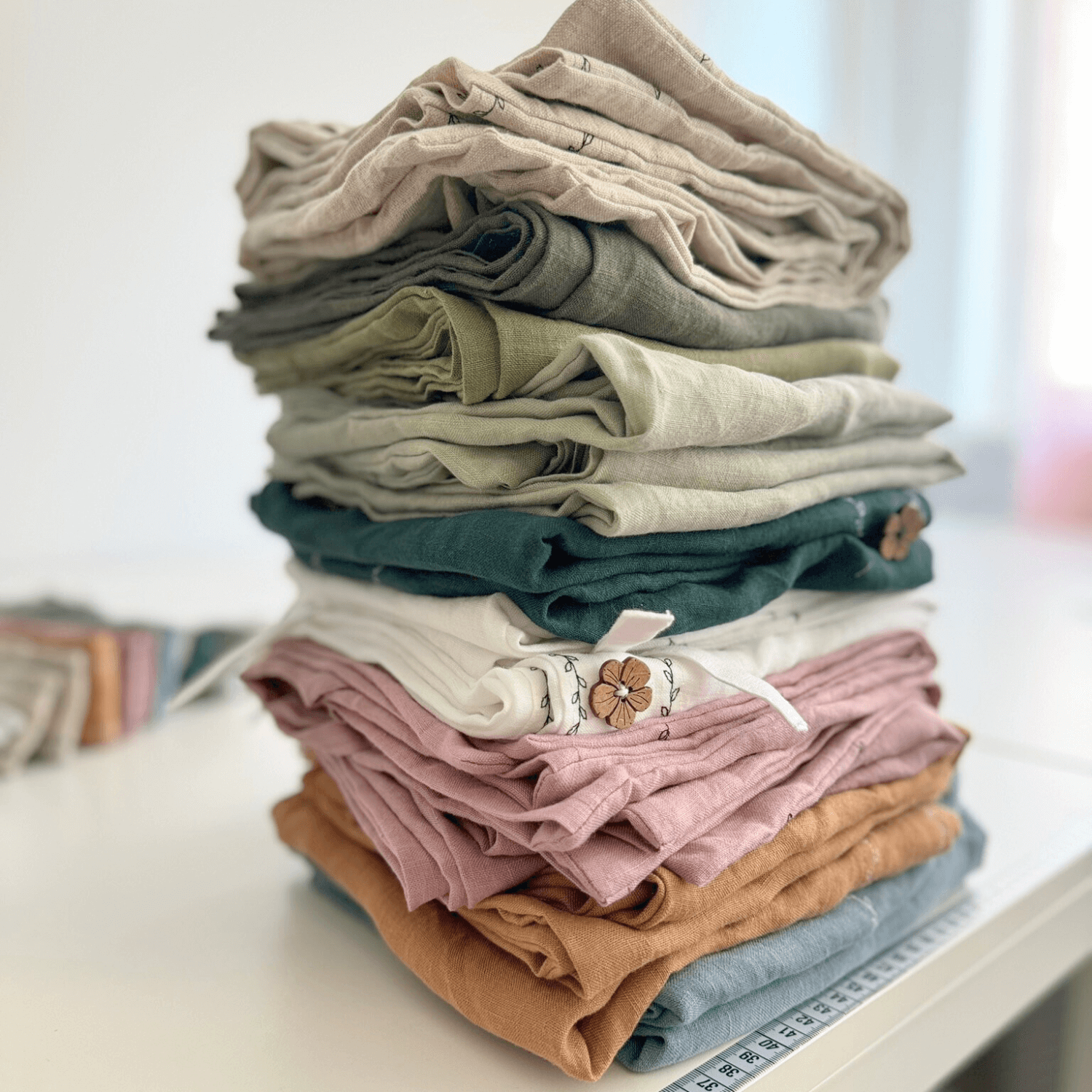 Folded linen fabrics stacked in natural and muted colors