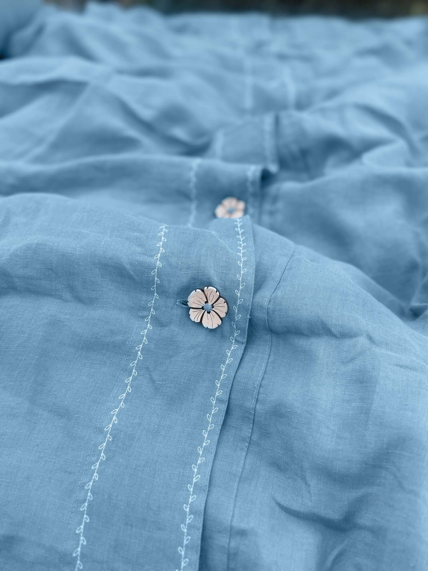 White embroidered linen bedding set on bed, bedroom lifestyle photo