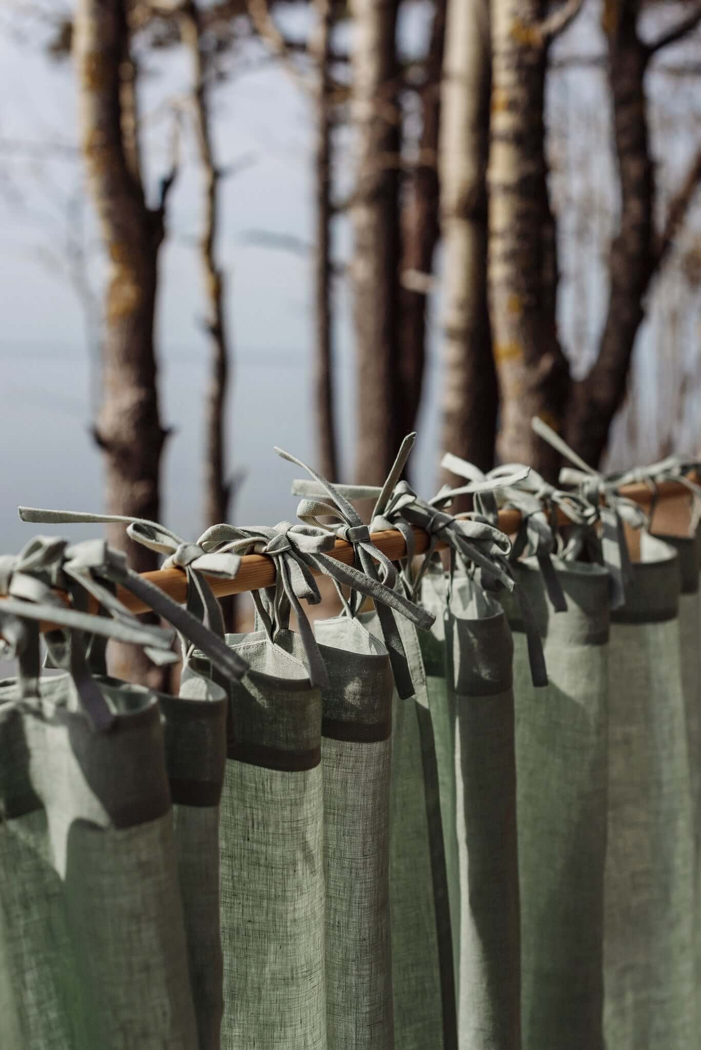 Close-up of green linen curtain ties hanging on a rod