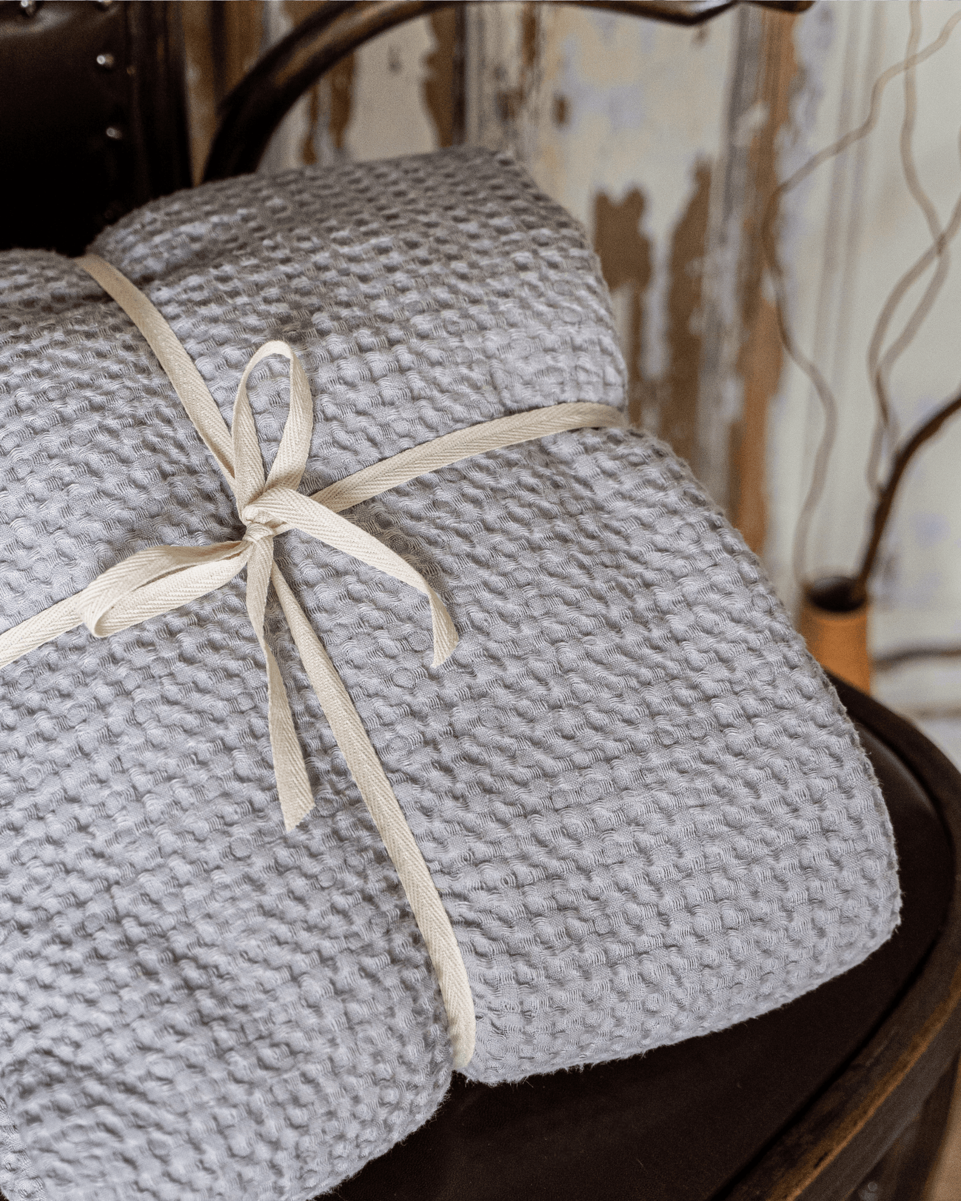 Large waffle blanket light grey - folded and stacked, tied with ribbon