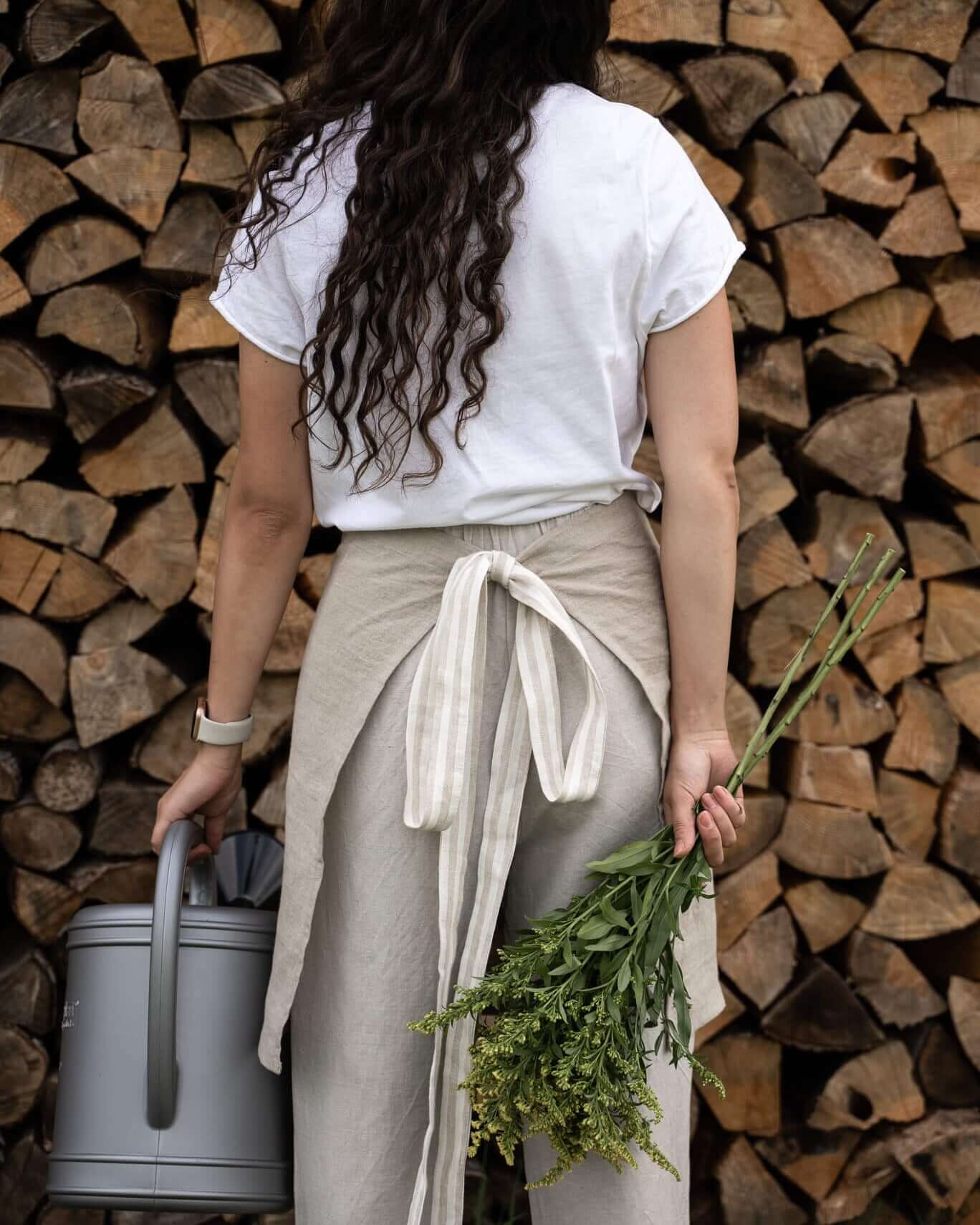 Woman in linen half apron in garden setting