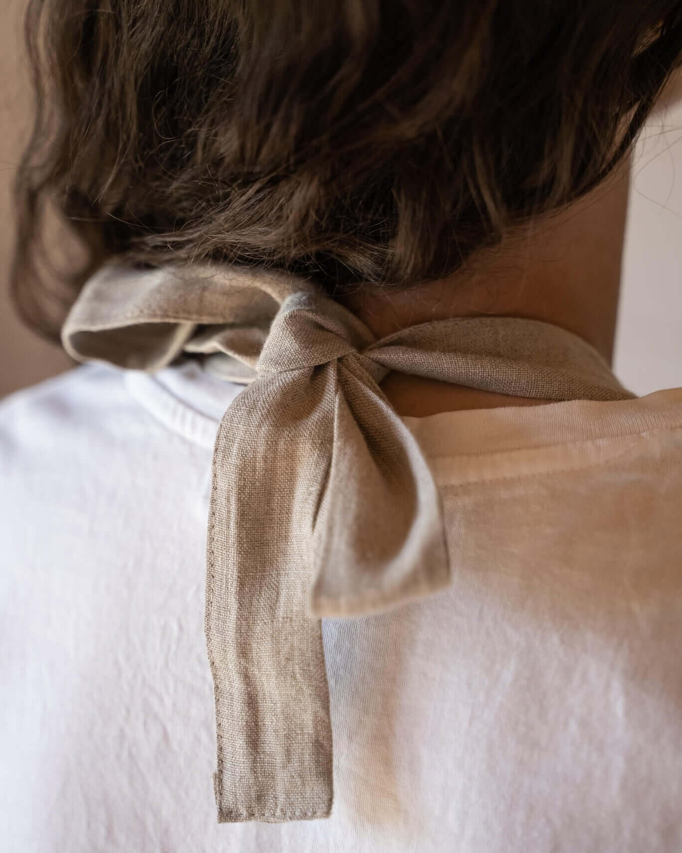 Linen apron close-up of bib detail and neck strap