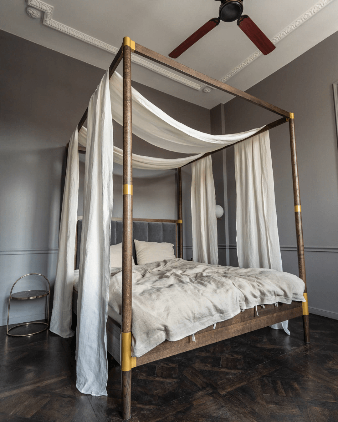 Linen canopy shawl on four-poster bed with ceiling fan, full drape view
