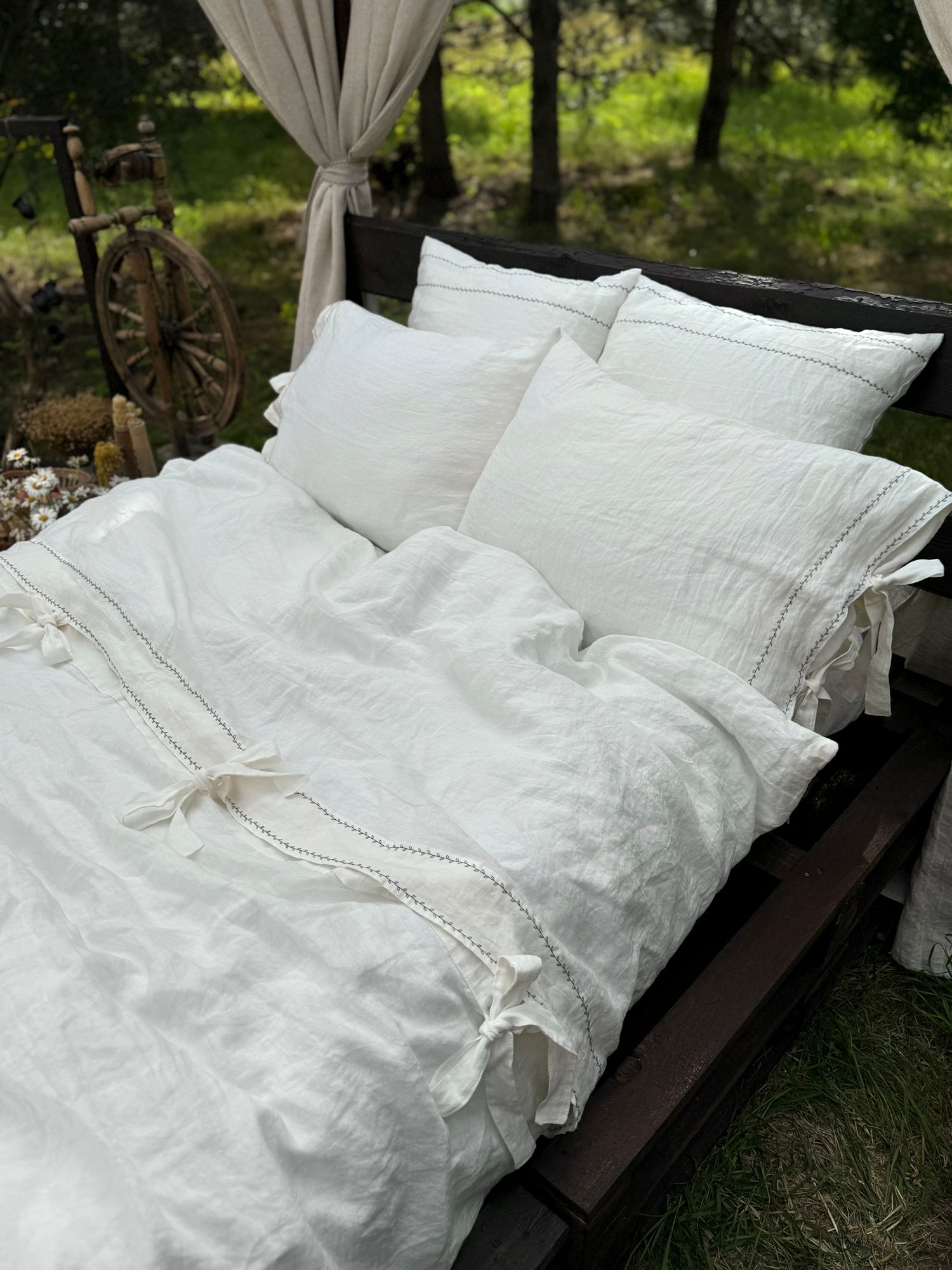Black embroidered linen duvet cover close-up, contrast embroidery detail