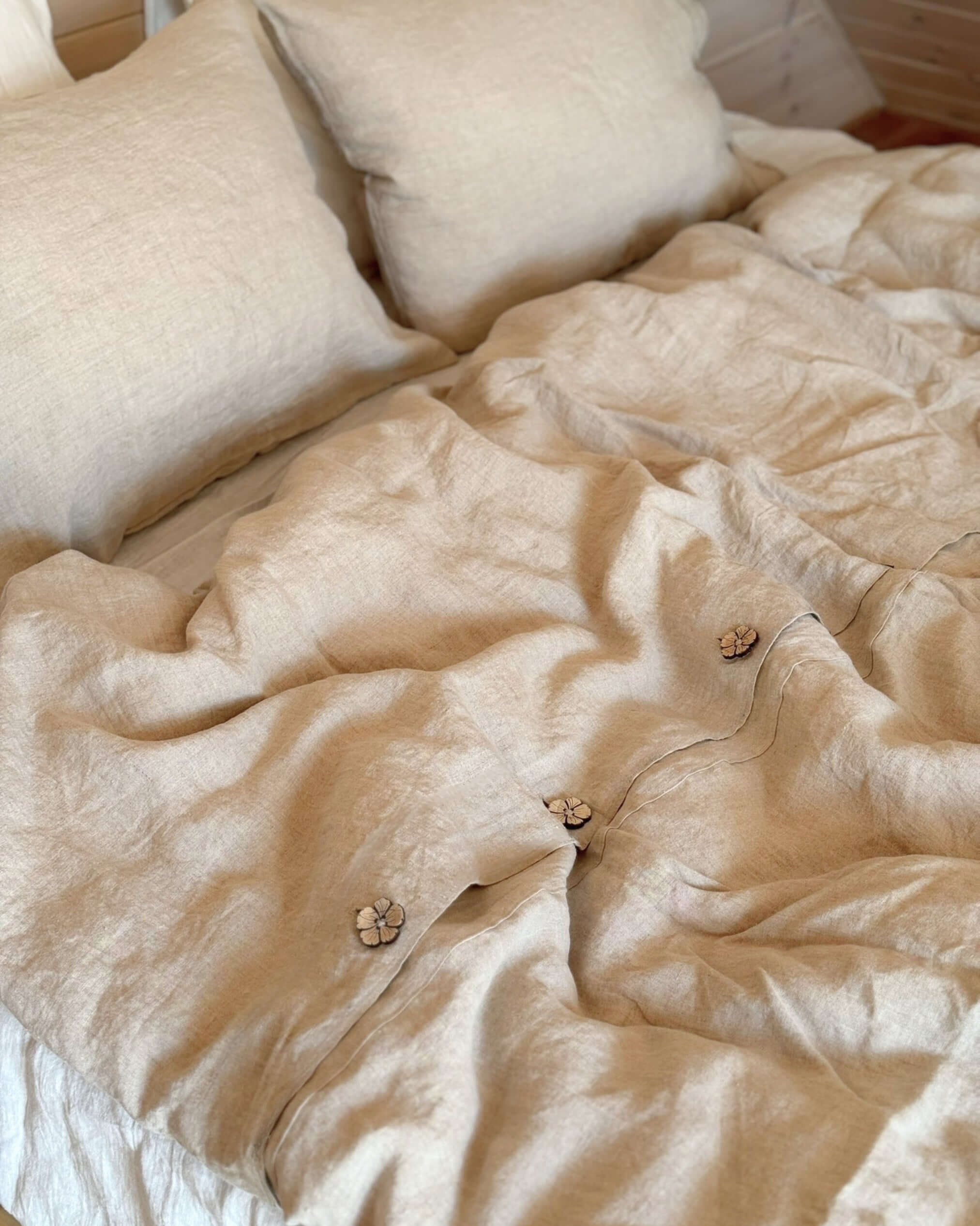 Minimalist linen duvet cover draped on bed, relaxed drape and natural texture