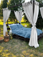 Linen canopy bed curtains with button tab tops on outdoor four-poster bed, white