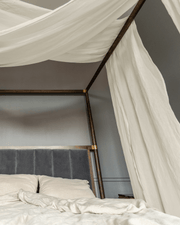 Linen canopy shawl draped on four-poster bed, scarf-style, front view