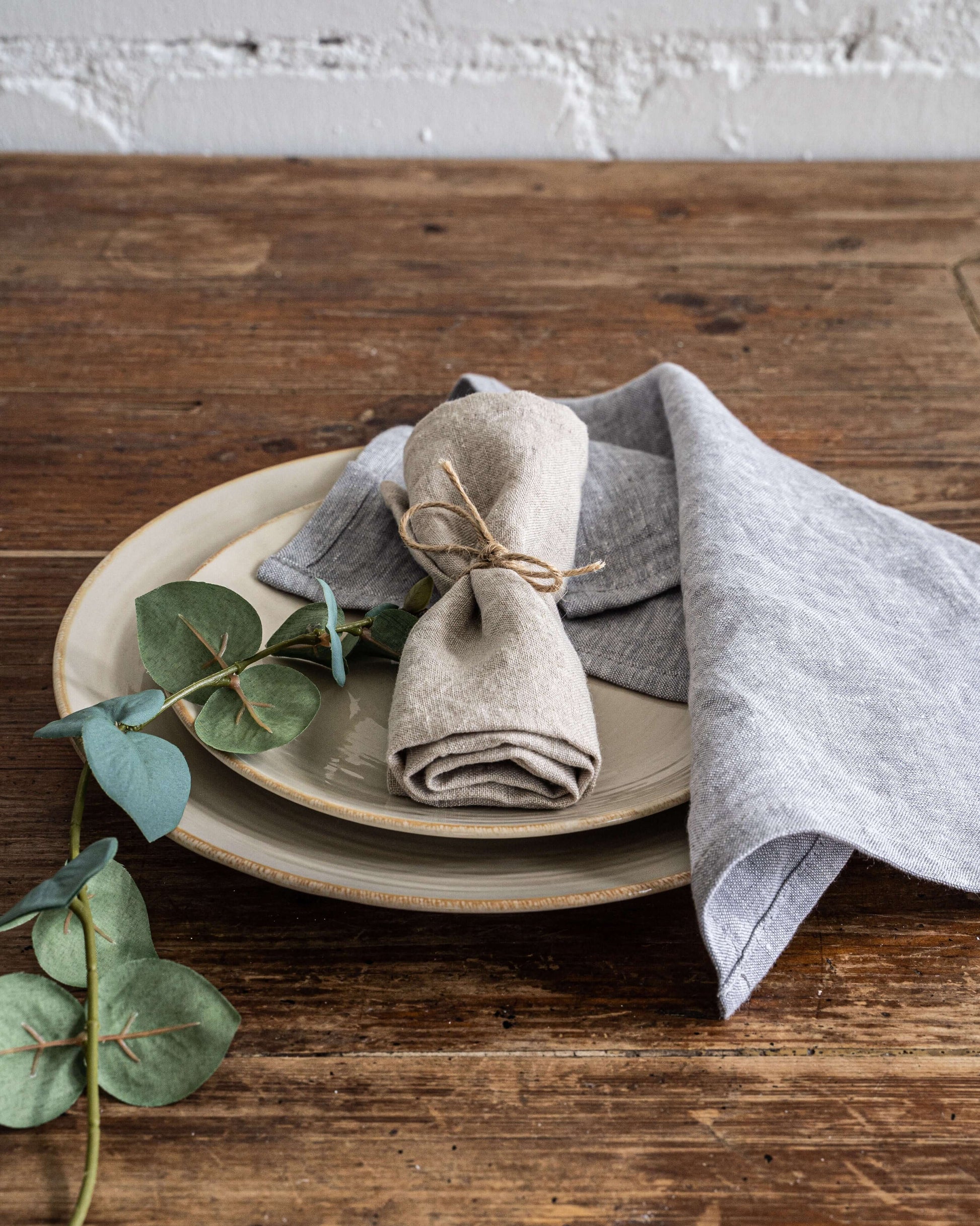 Linen napkin folded on plate with cutlery, table setting detail