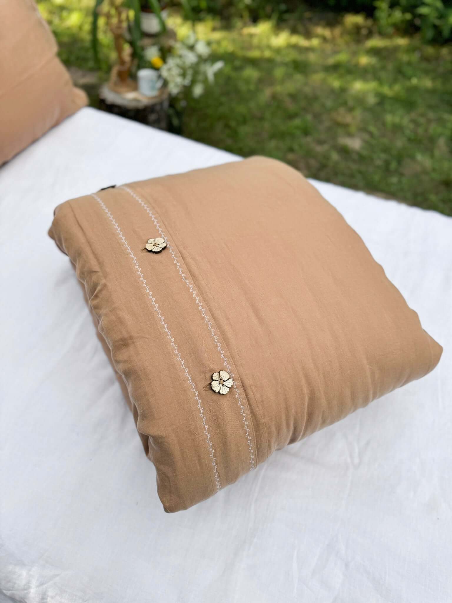 White embroidered linen duvet cover with camel brown linen pillowcase