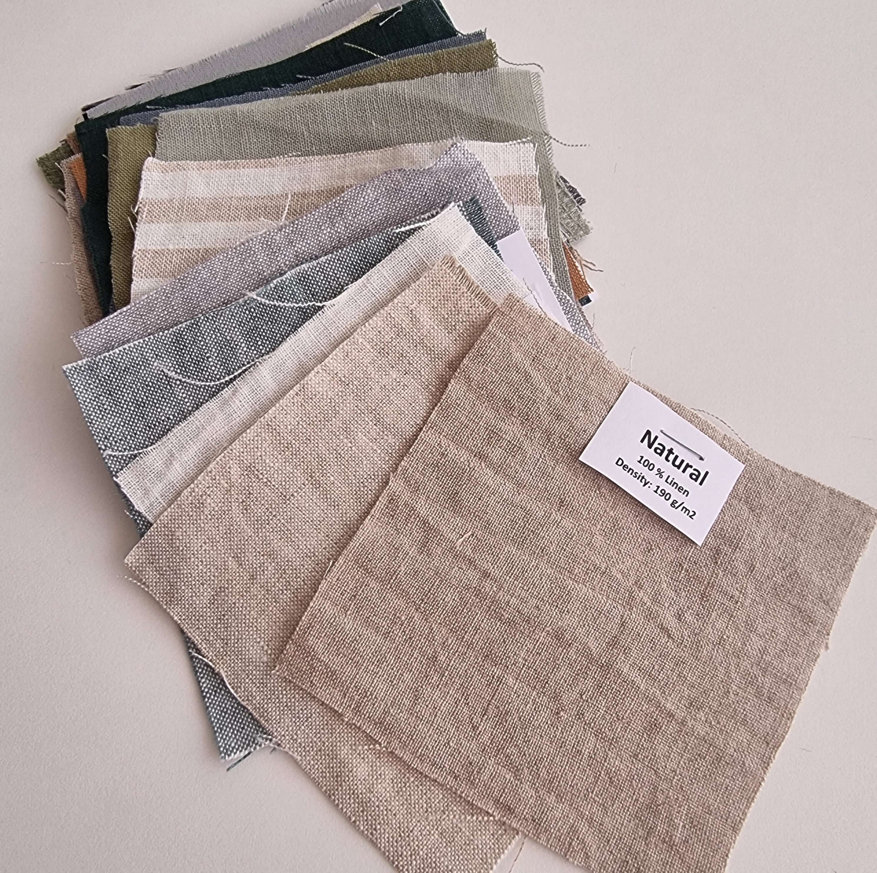 Multiple linen fabric swatches fanned out, available color range