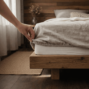 Linen fitted sheet on bed, natural tone, corner fitted detail