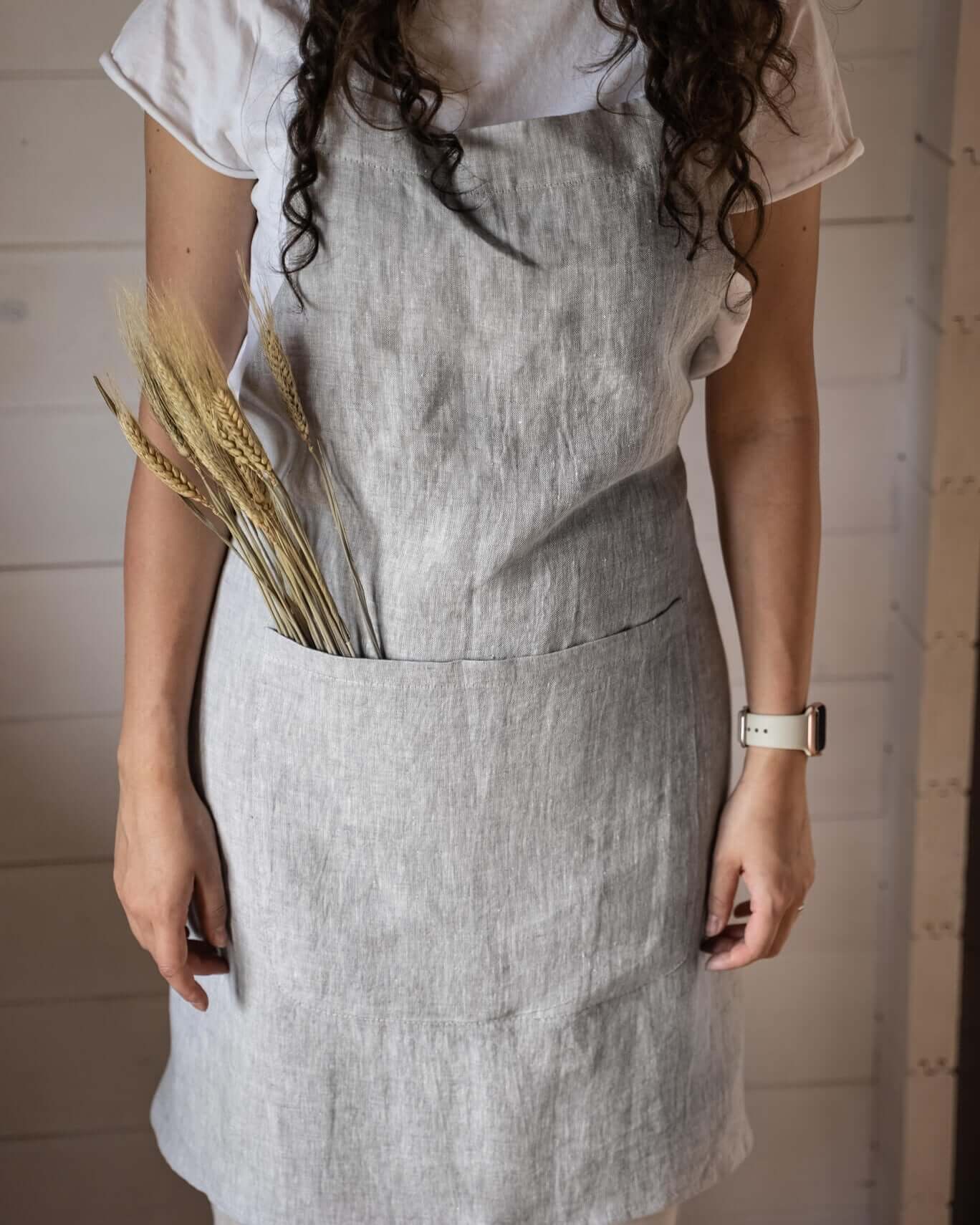 Linen apron in natural tone, side view showing full length