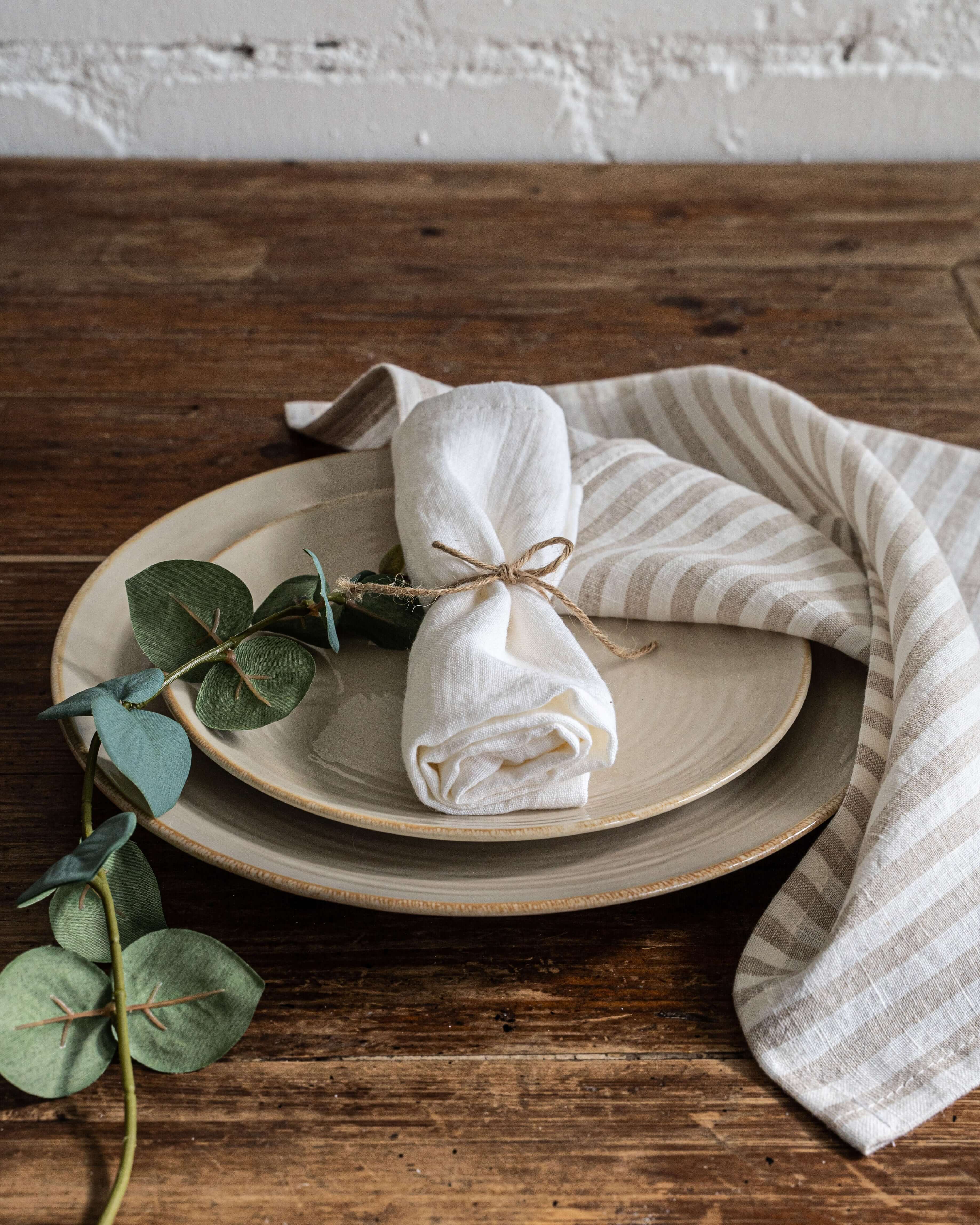 Linen napkin 40x40 cm, natural tone, folded on plate
