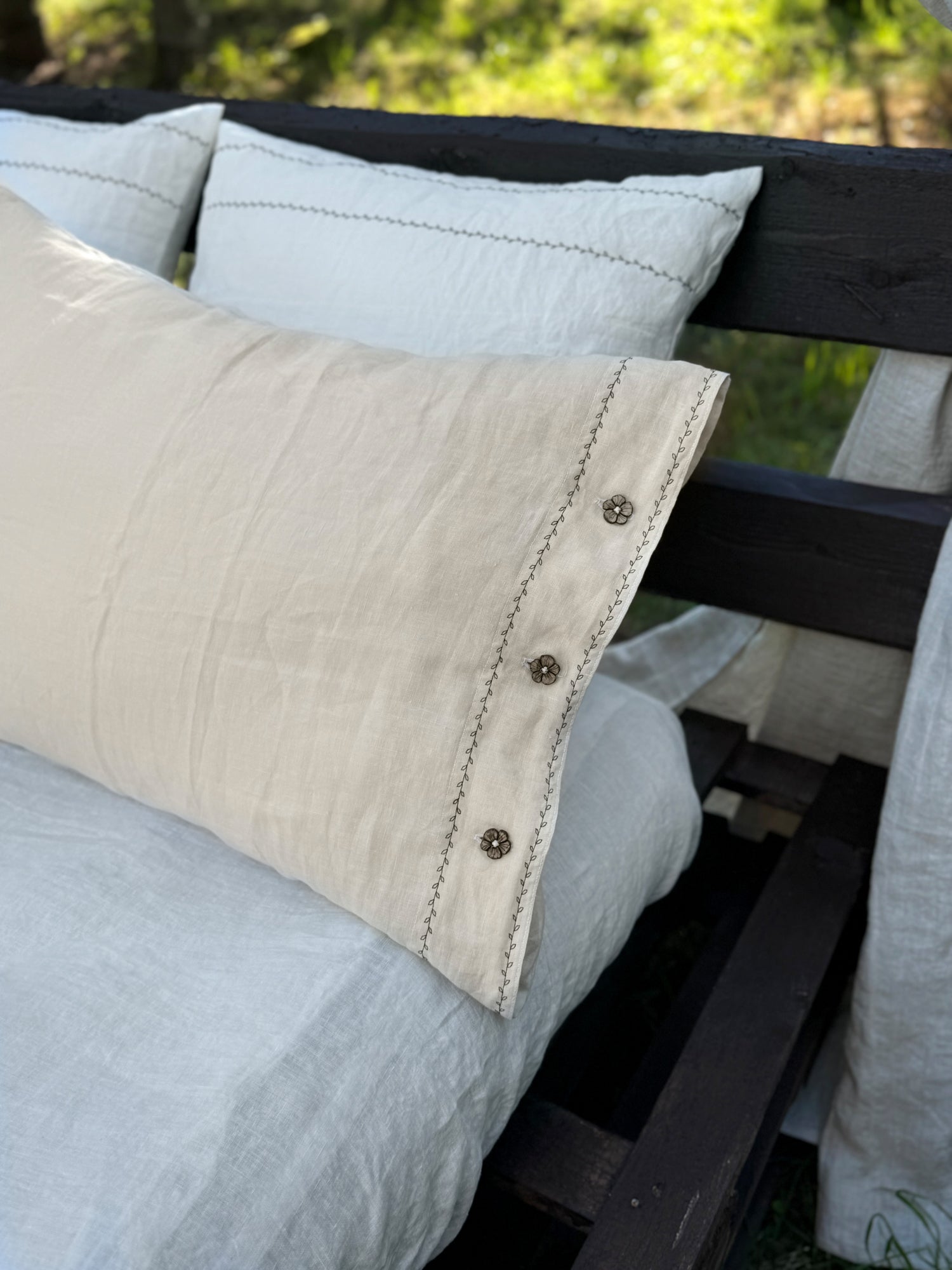 Black embroidered linen pillowcase close-up, embroidery and linen texture