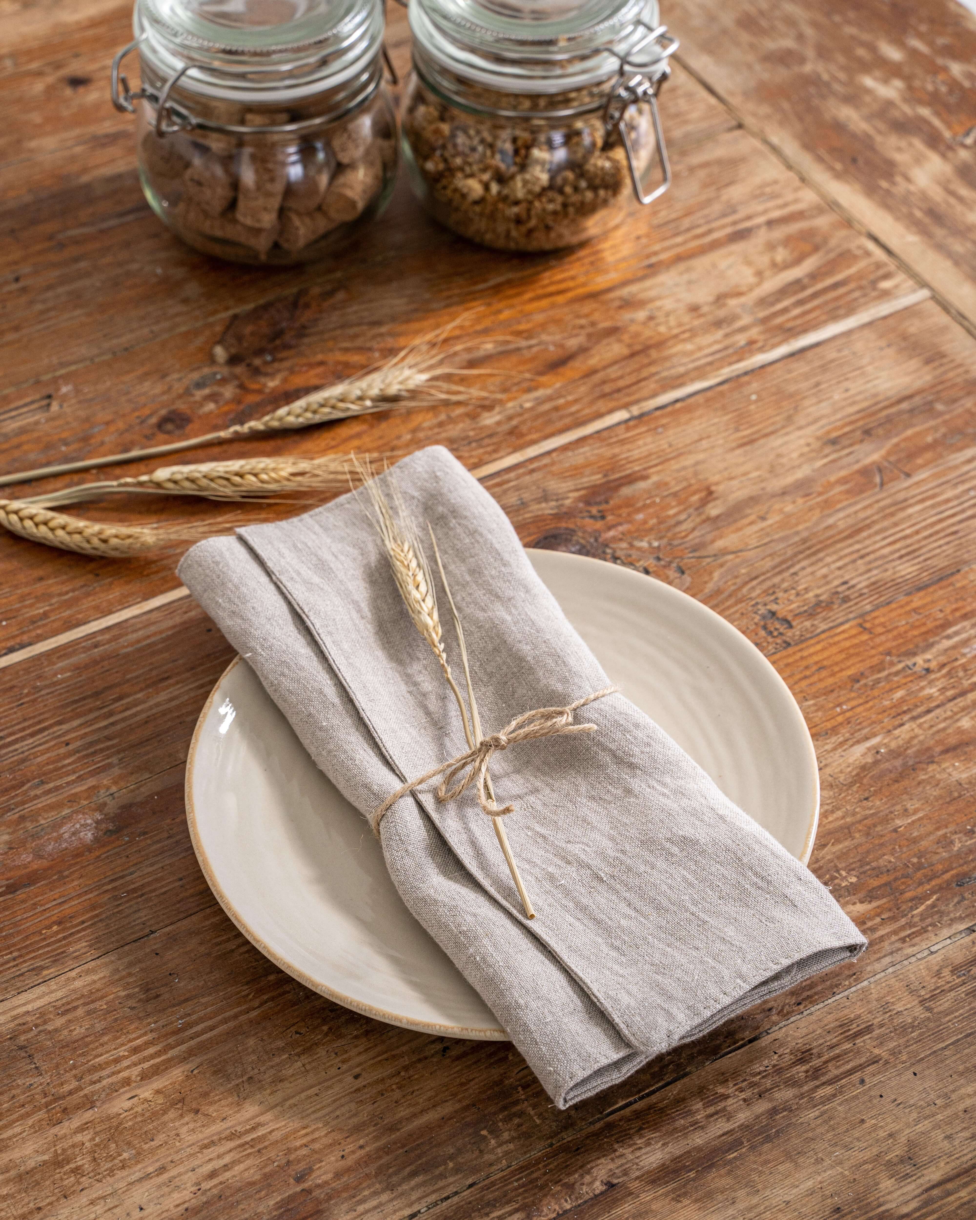 Linen placemat on dining table with ceramic plate and cutlery
