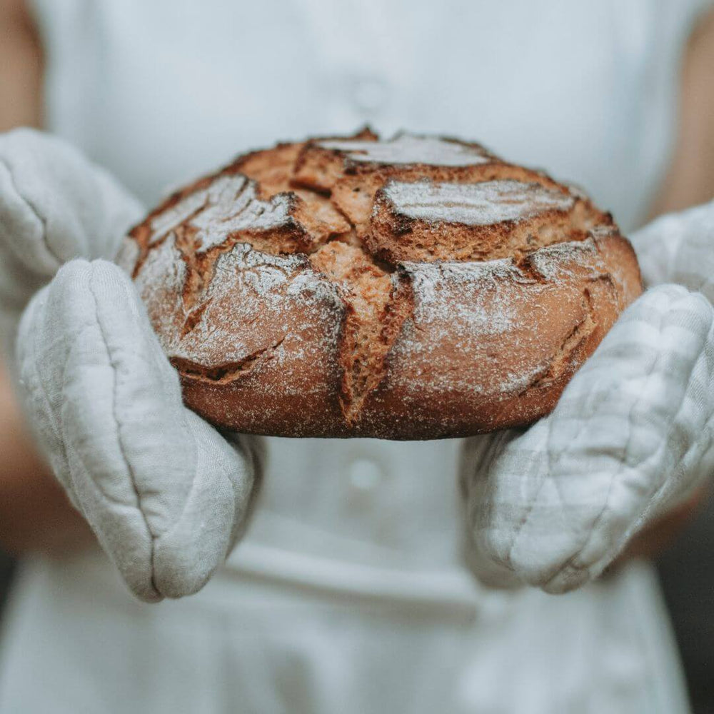 Linen pot holder with bread and autumn harvest, lifestyle flat lay