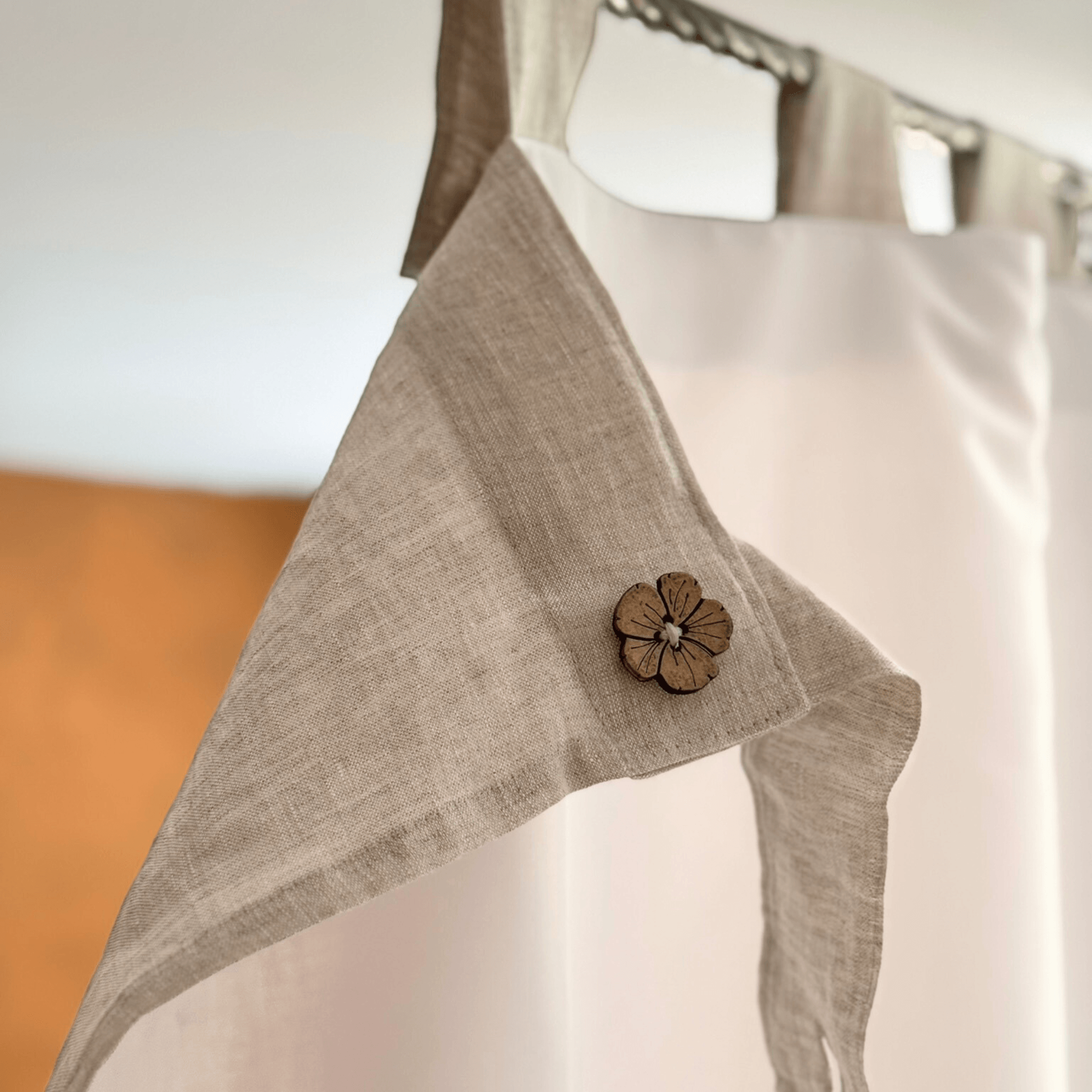 Close-up of linen shower curtain tab top with a natural button detail