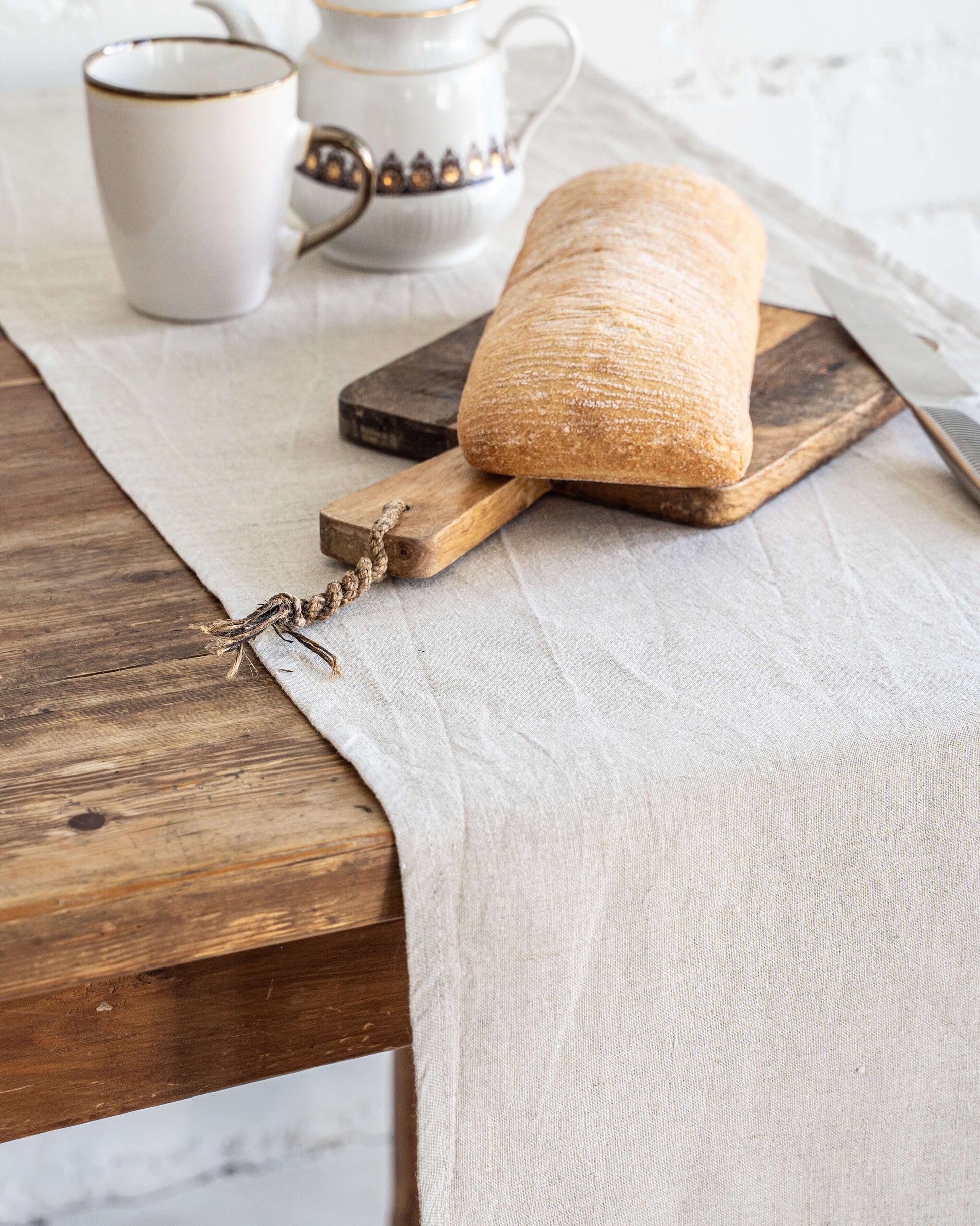 Linen table runner draped over table edge, showing drape and length