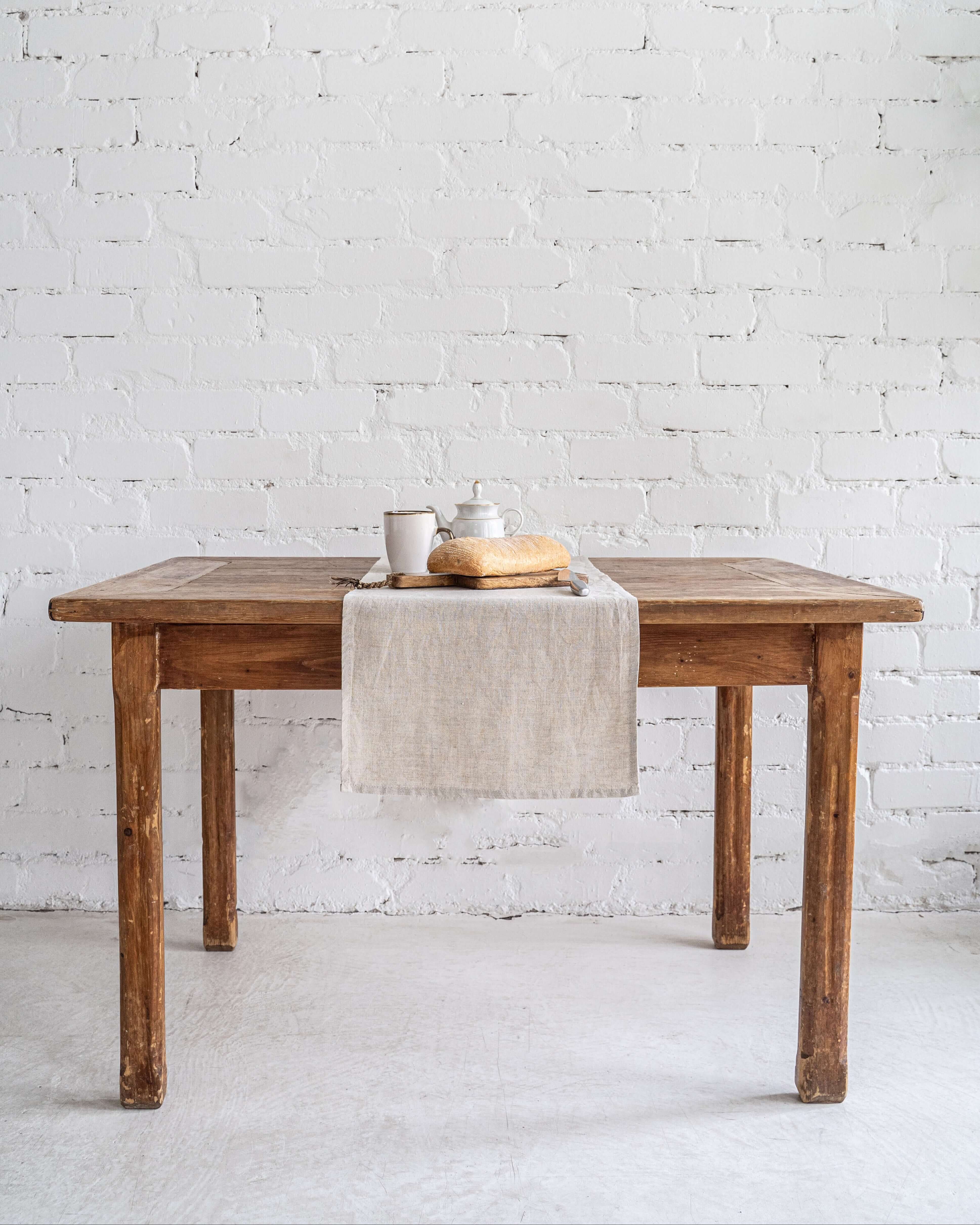 Linen table runner on sideboard with decorative objects