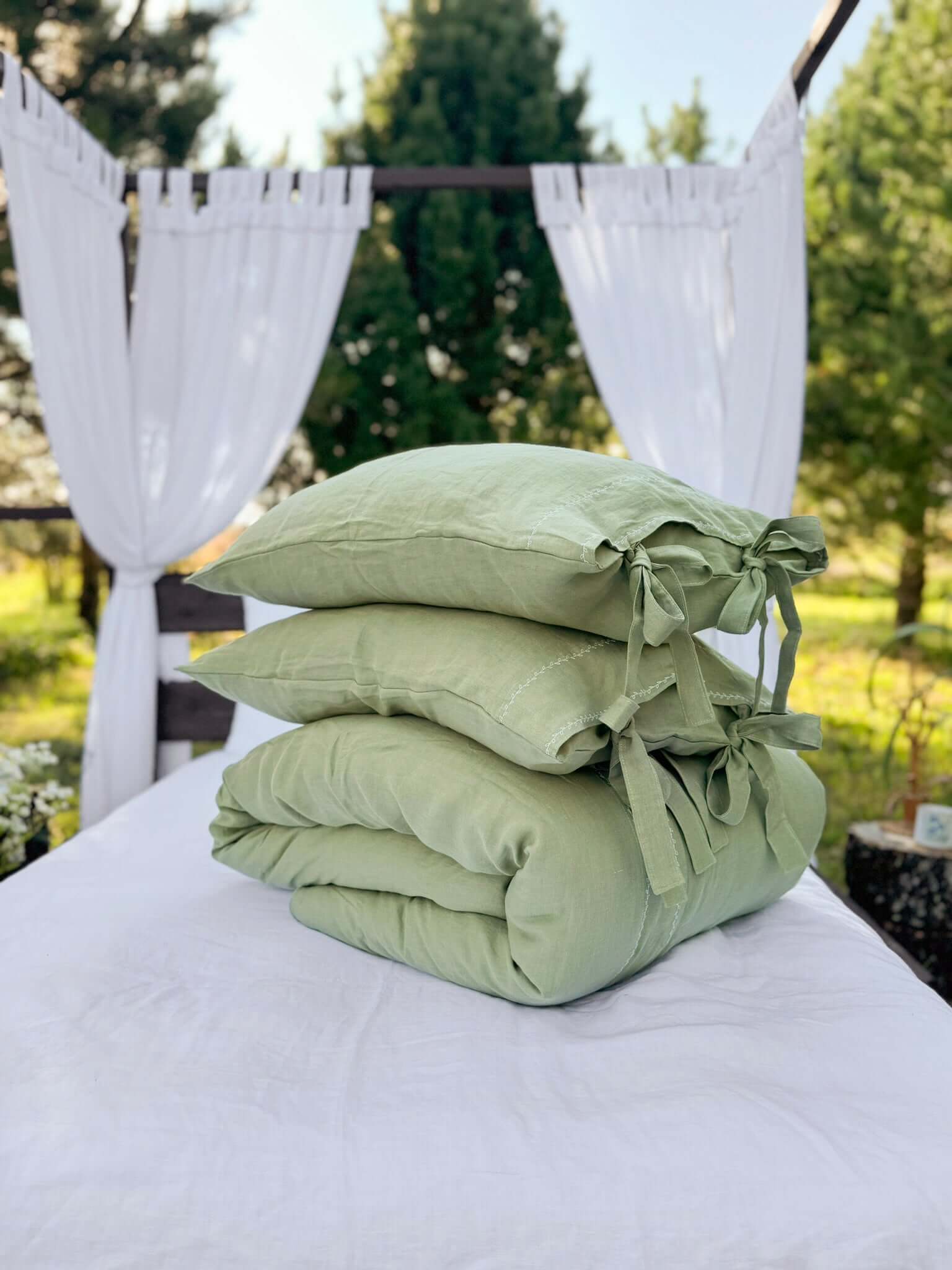 White embroidered linen bedding set, corner and stitching detail