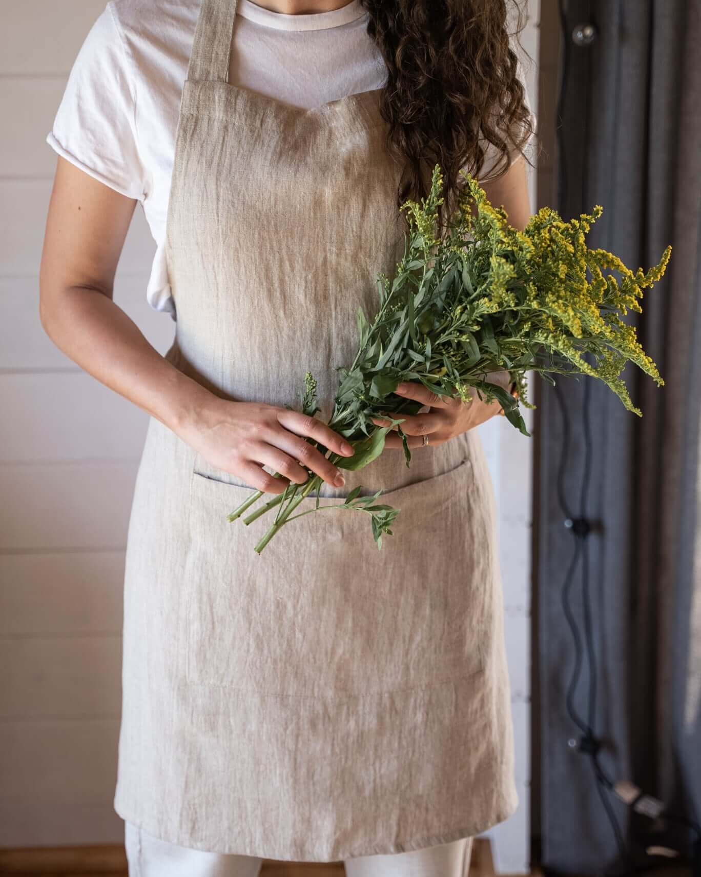 Linen apron in natural tone, front view, waist tie detail