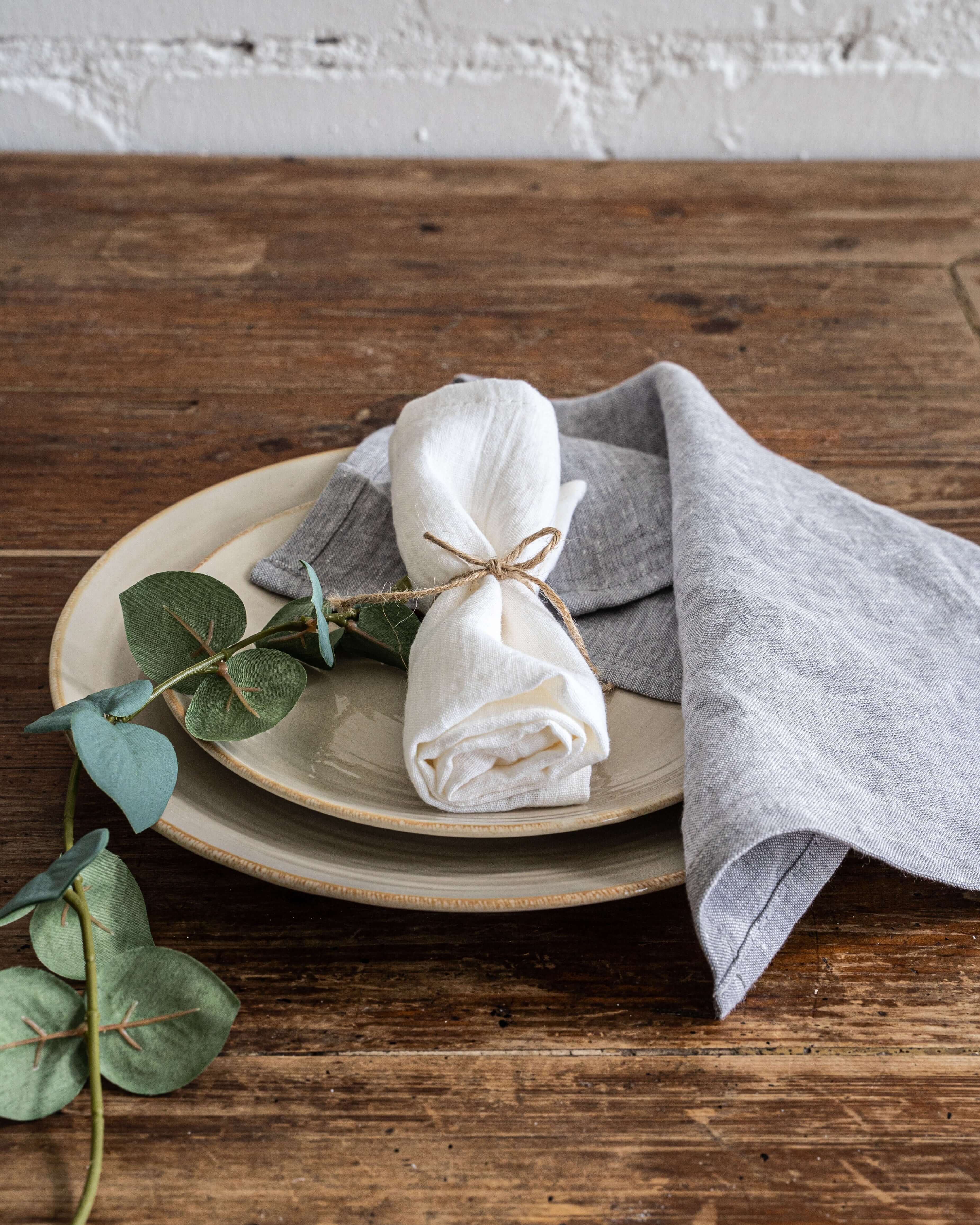 Linen napkin on dining table with ceramic tableware, top view