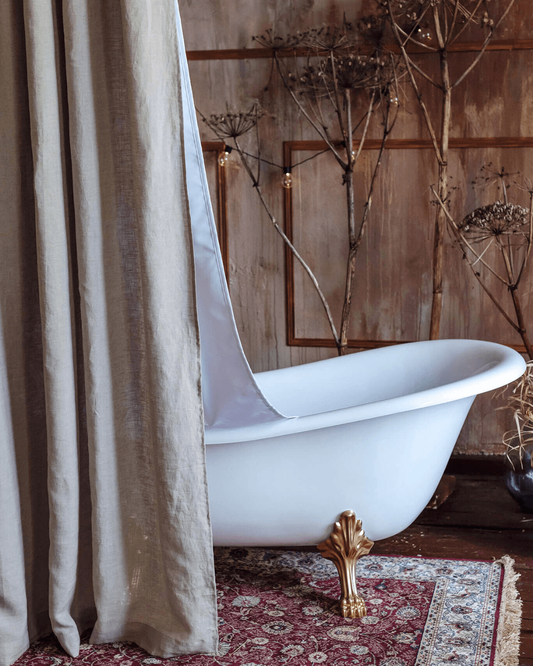 Natural linen shower curtain beside freestanding bathtub, full length view