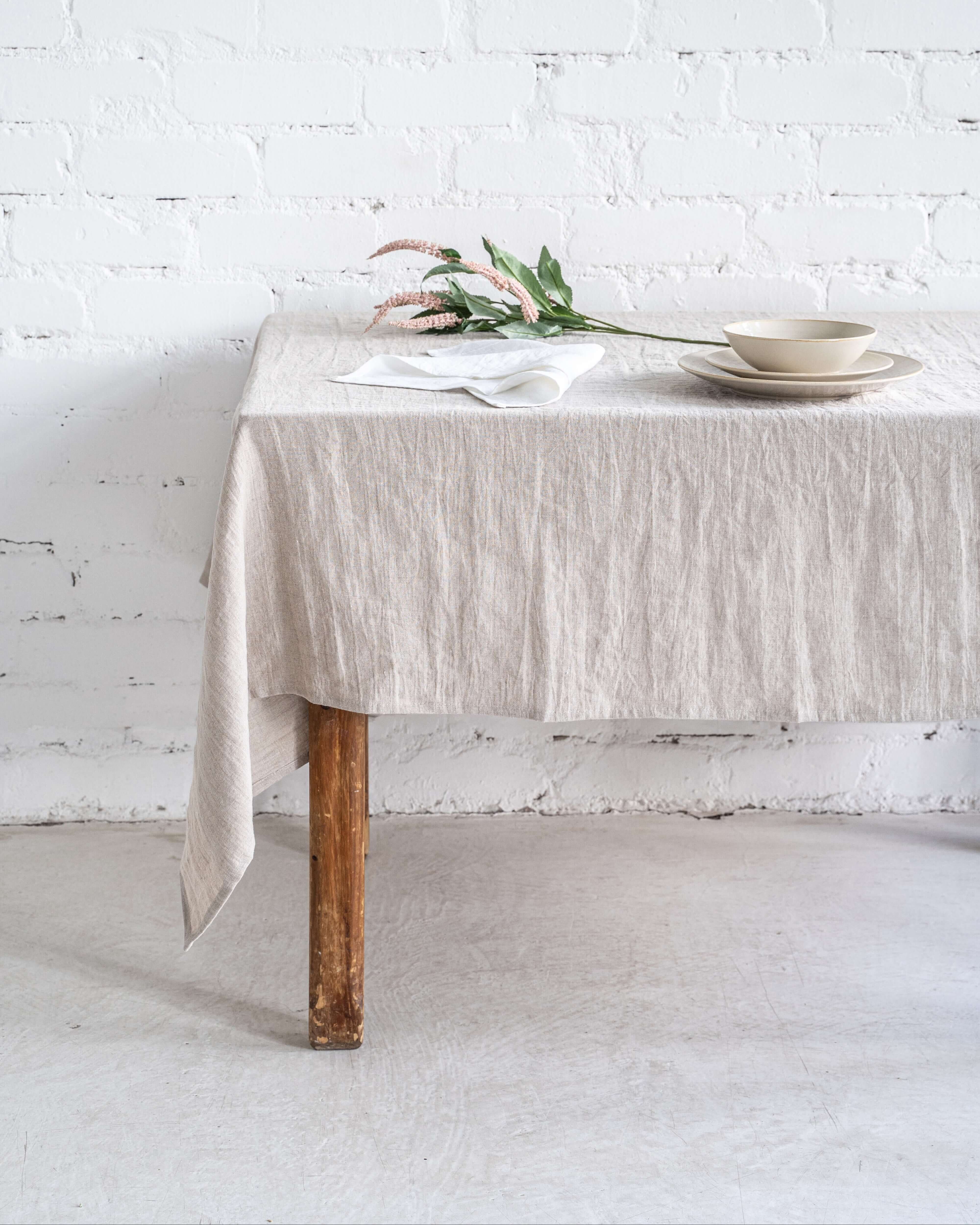 Linen tablecloth with natural overhang on wooden dining table