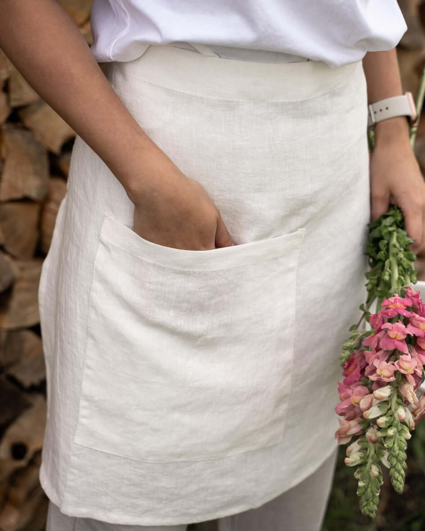 Linen half apron worn by woman in kitchen, full front view