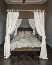 Off white tie-top linen canopy curtains on four-poster bed, front view