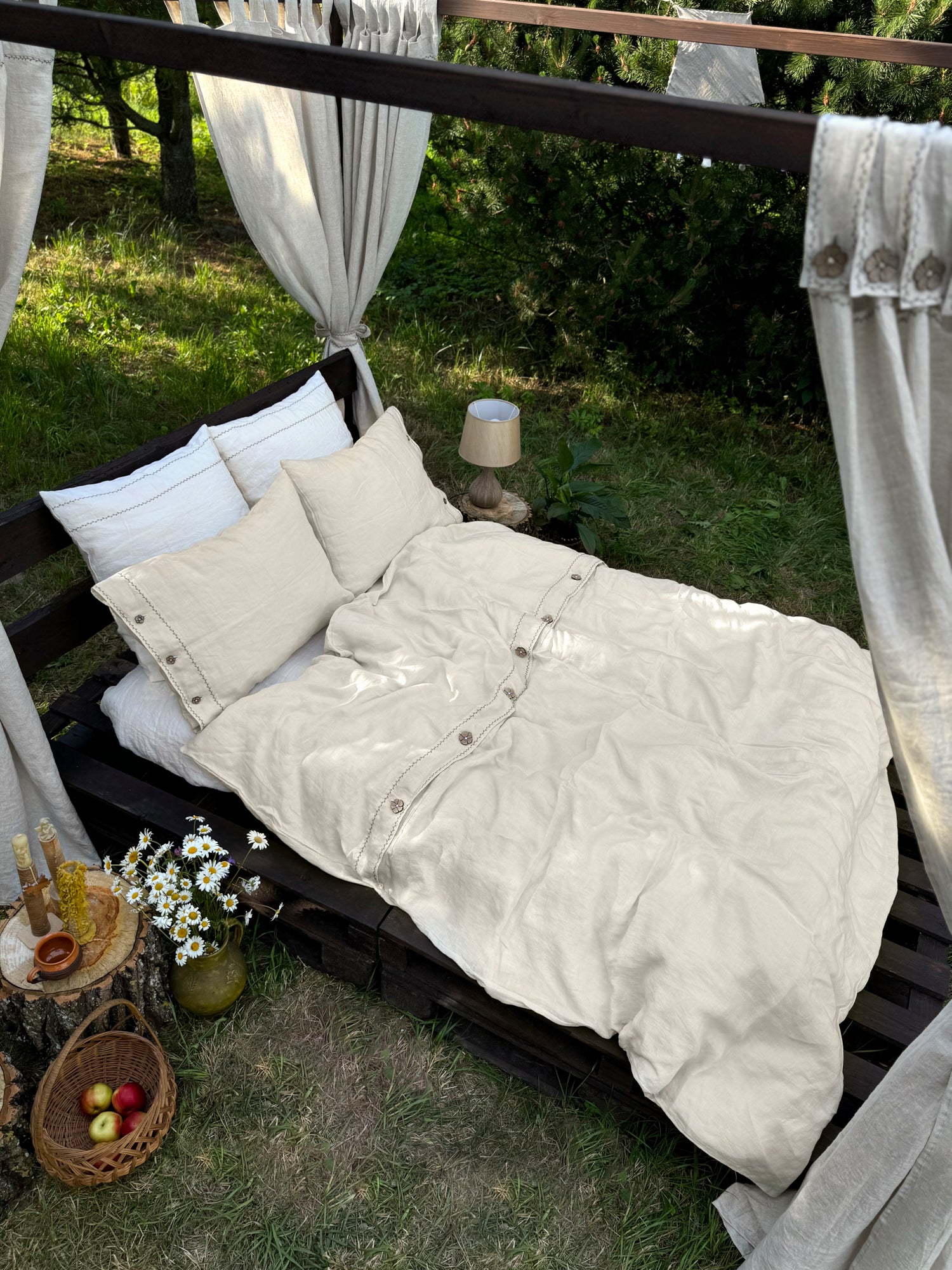 Reverse side of black embroidered linen duvet cover, top closure detail