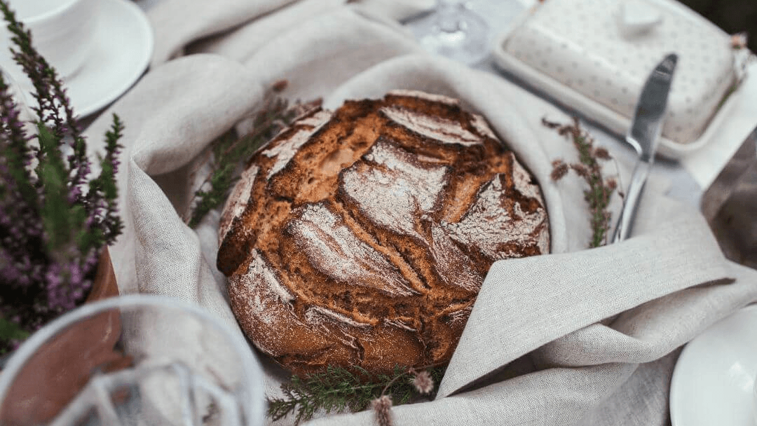 Linen tea towel with artisan bread, natural lifestyle flat lay