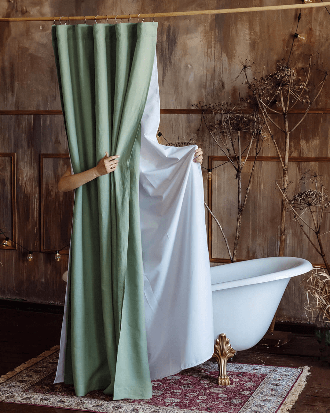 Sage green linen fabric shower curtain in minimalist bathroom with bathtub