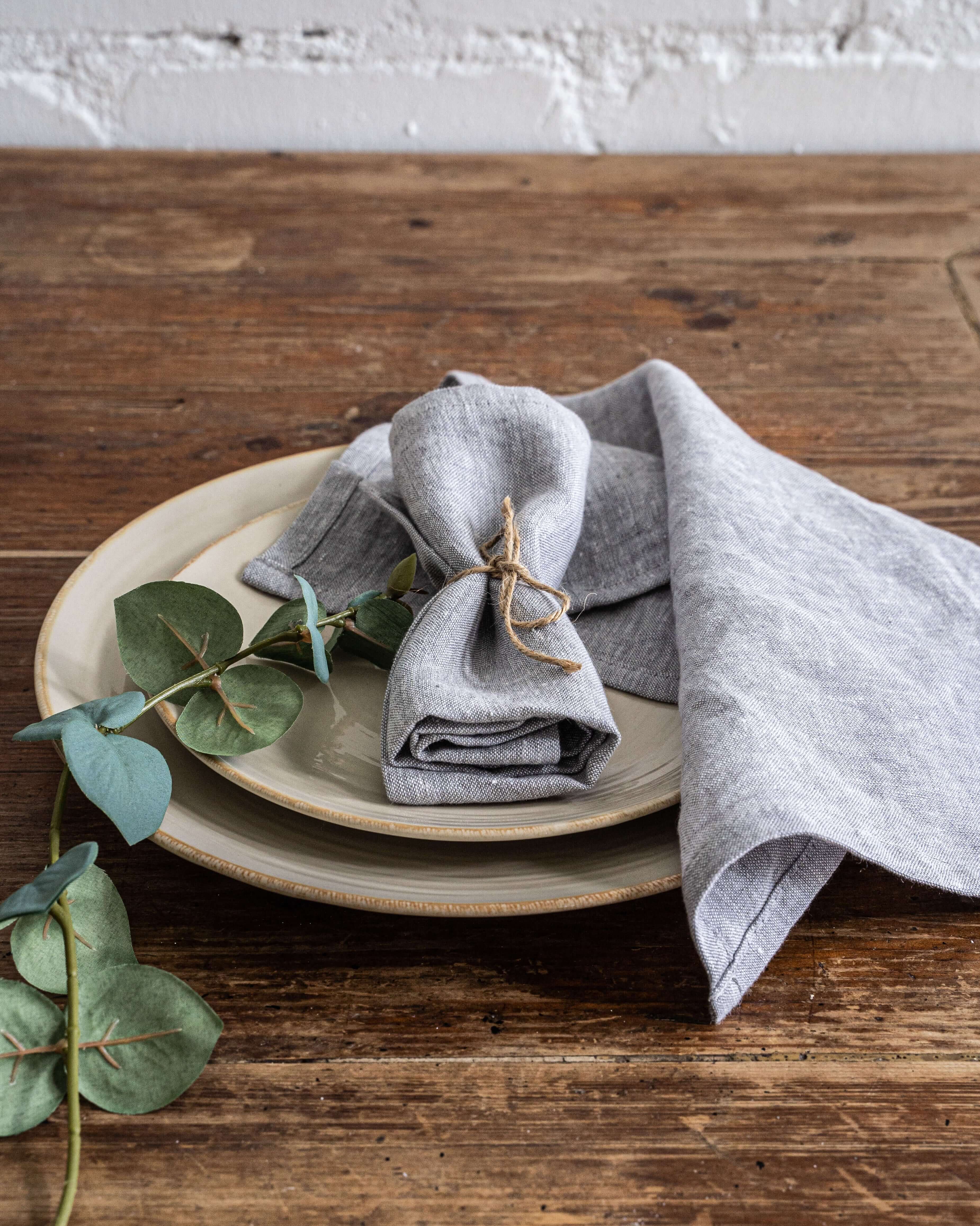 Linen napkins stacked on dining table, natural tone color