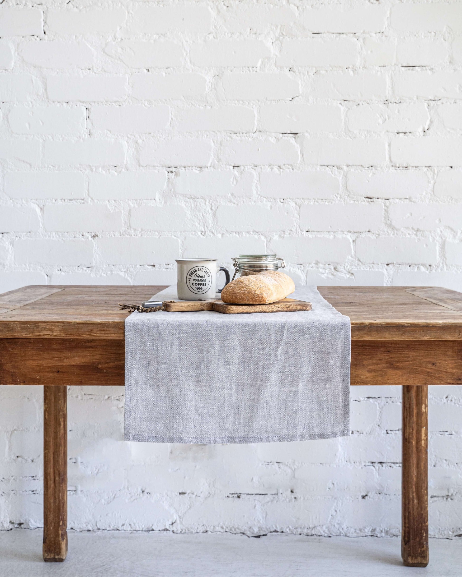 Linen table runner on long dining table, full length view