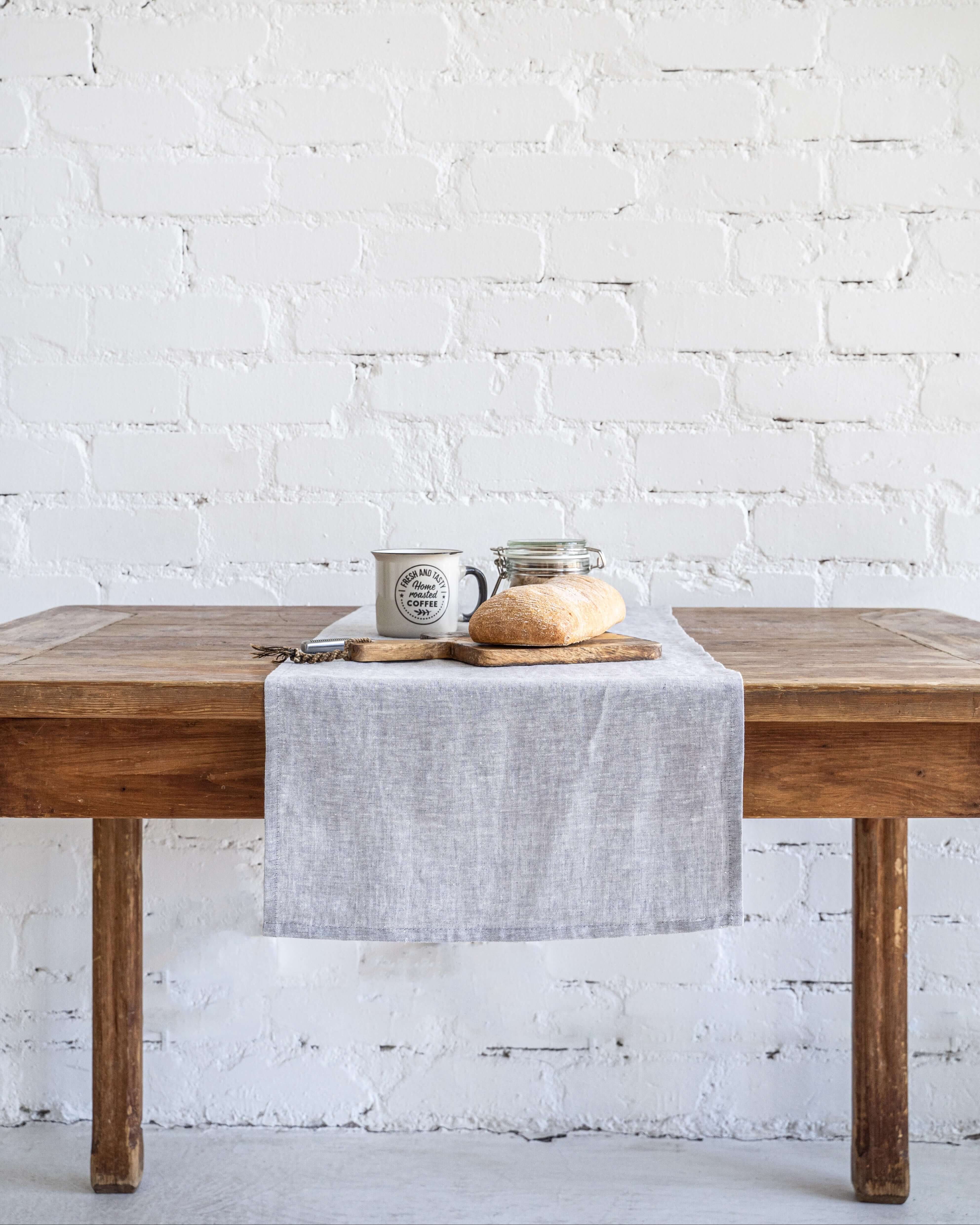 Linen table runner on long dining table, full length view