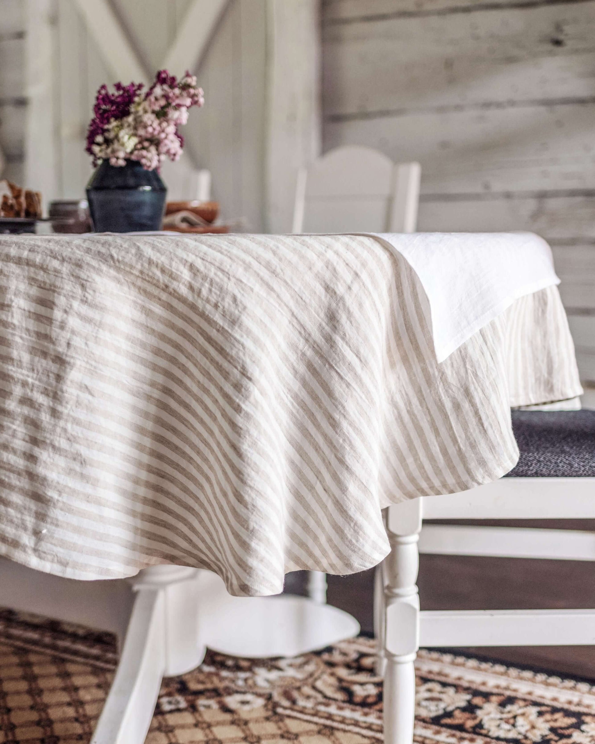 Oval linen tablecloth close-up showing hemmed edge and fabric