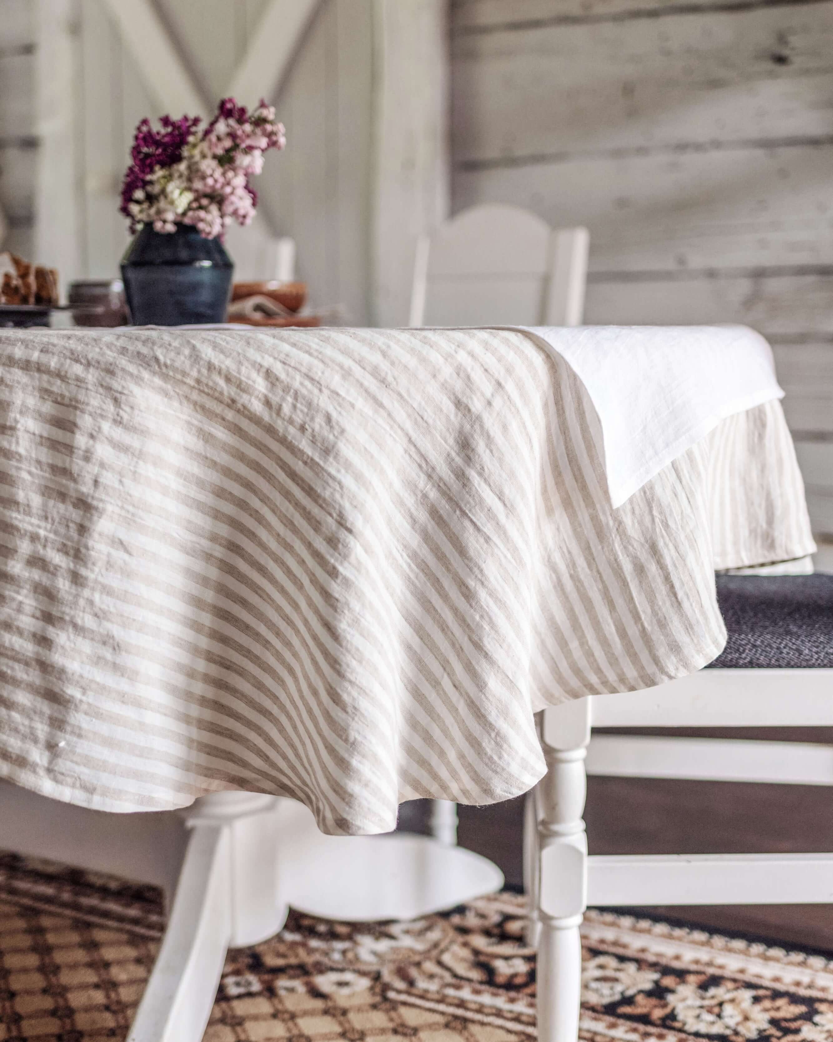 Oval linen tablecloth close-up showing hemmed edge and fabric