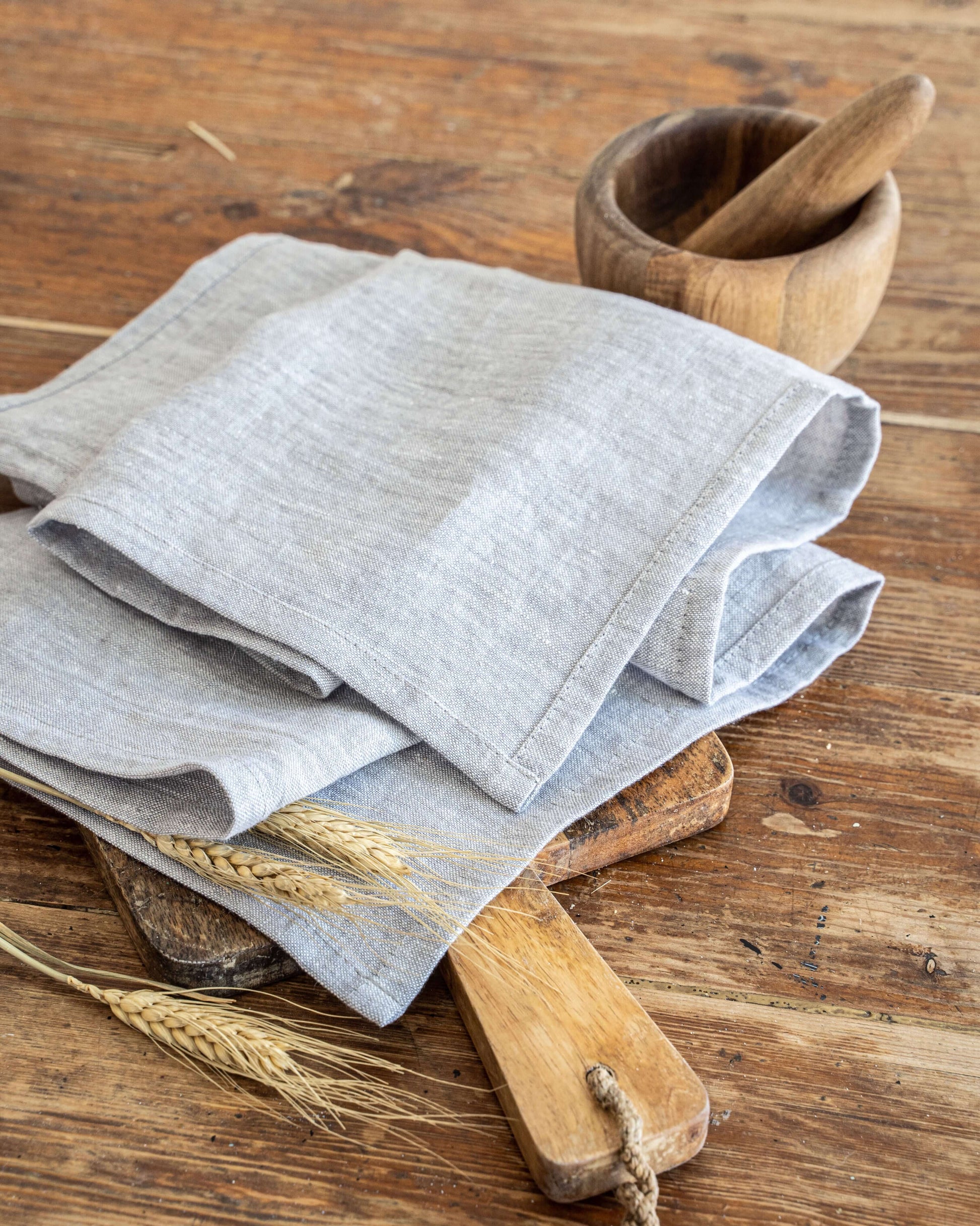 White linen tea towel folded on kitchen surface