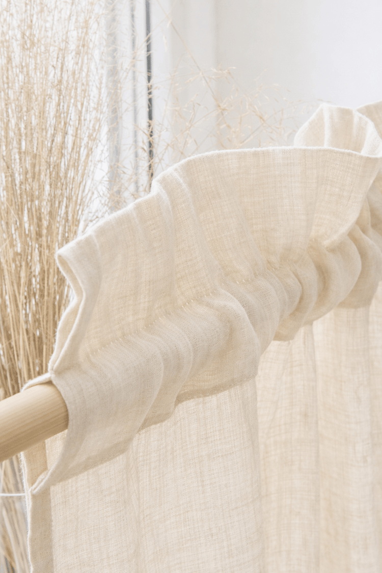 White textured linen curtain with crowned rod pocket edge detail
