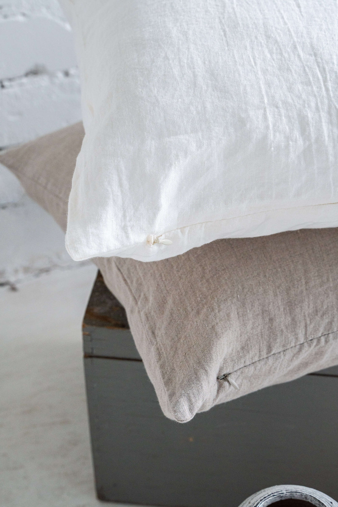 Close-up of white linen pillowcase showing zipper detail