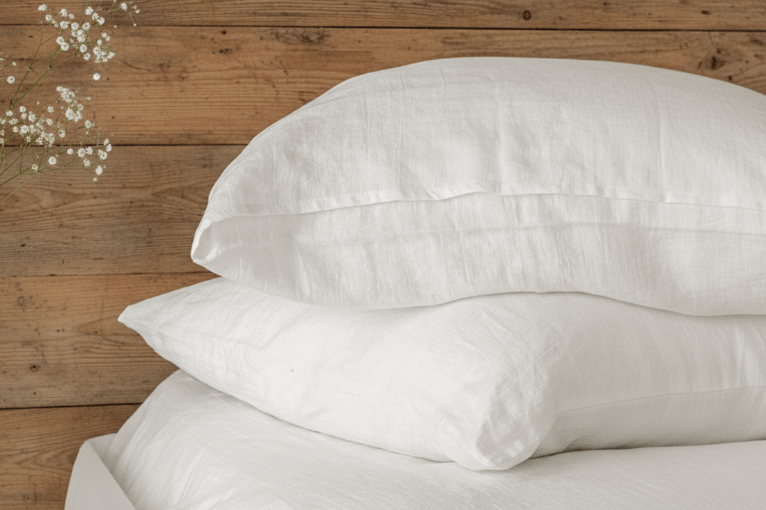 White linen pillow cover (envelope) on bed, minimalist bedroom styling