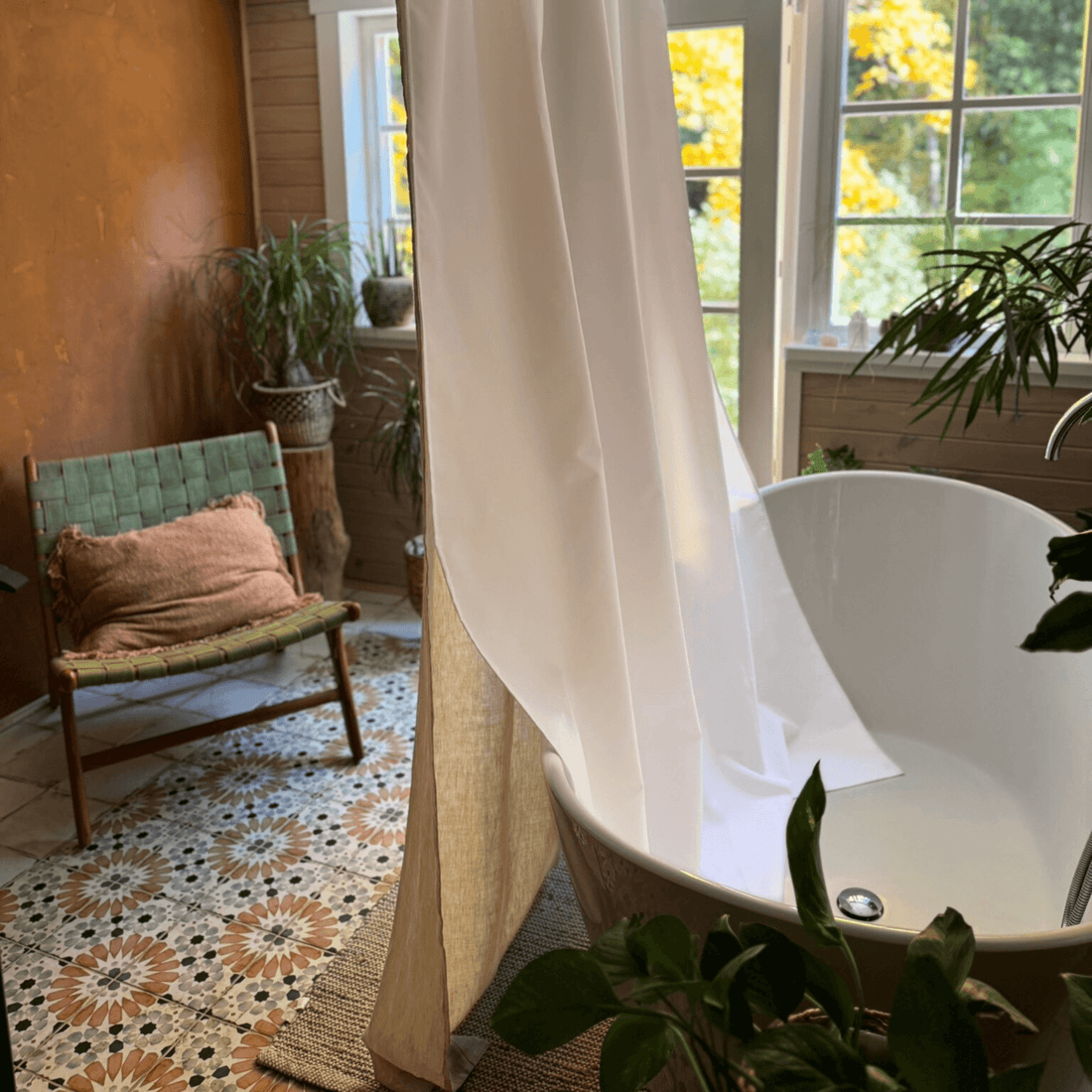 Heavy linen shower curtain panel in bright room with outdoor view
