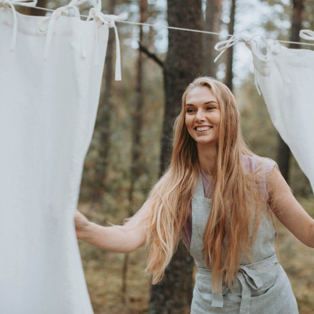 Woman holding natural linen fabric outdoors, artisan craftsmanship