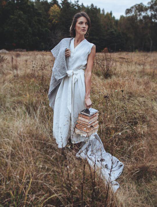Woman in white linen outfit outdoors, European linen lifestyle