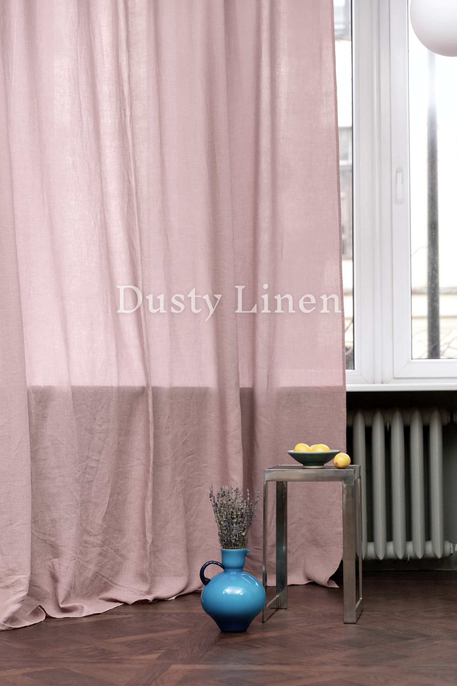 a blue vase sitting on top of a table next to a window