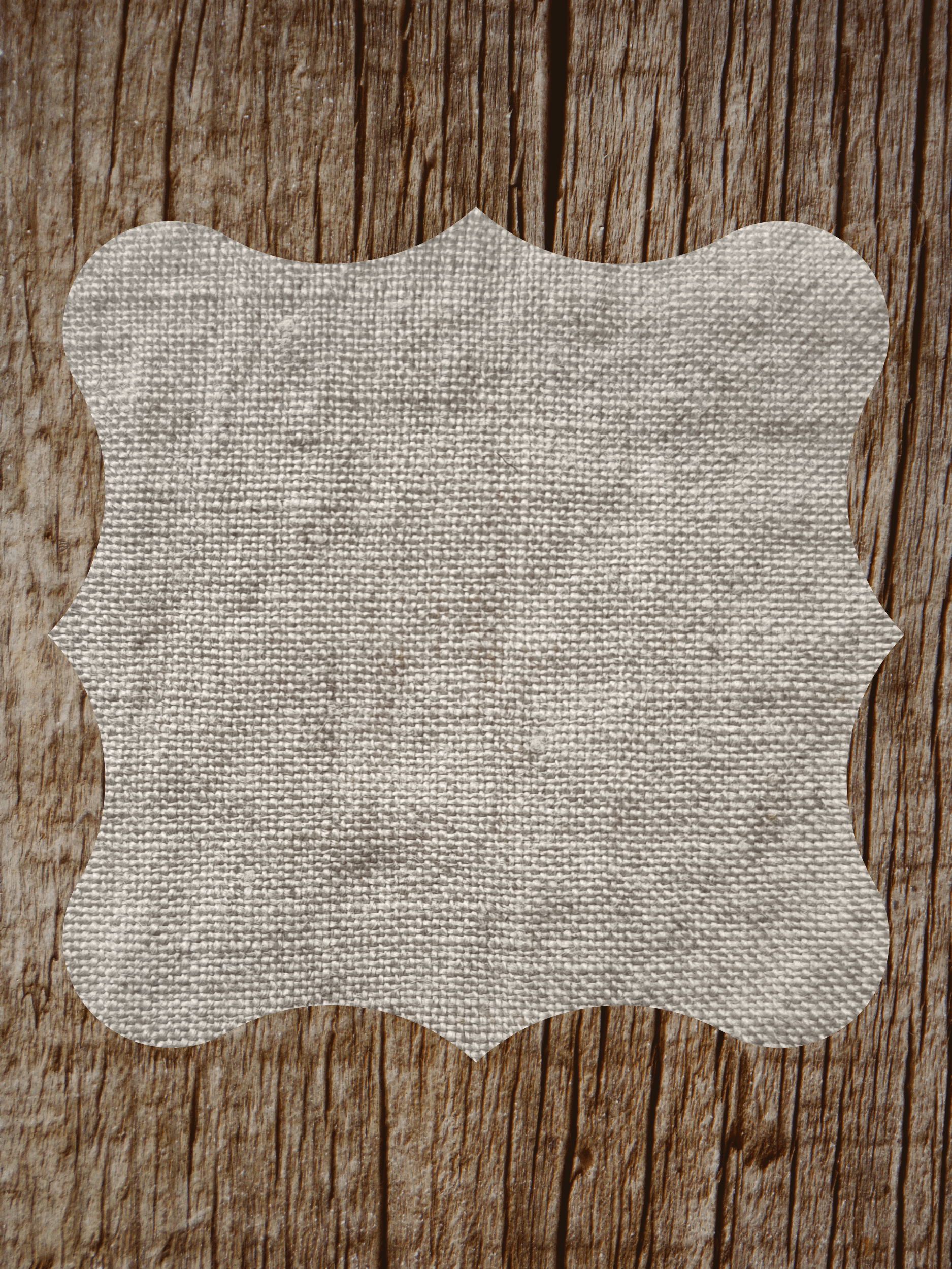 a piece of cloth with a white frame on a wooden surface