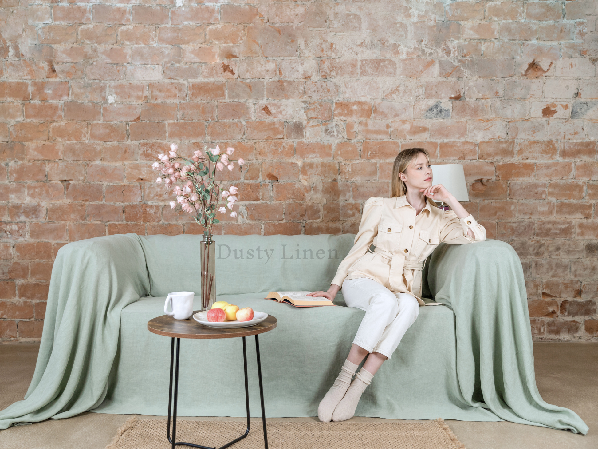 a woman sitting on a couch with a cup of coffee