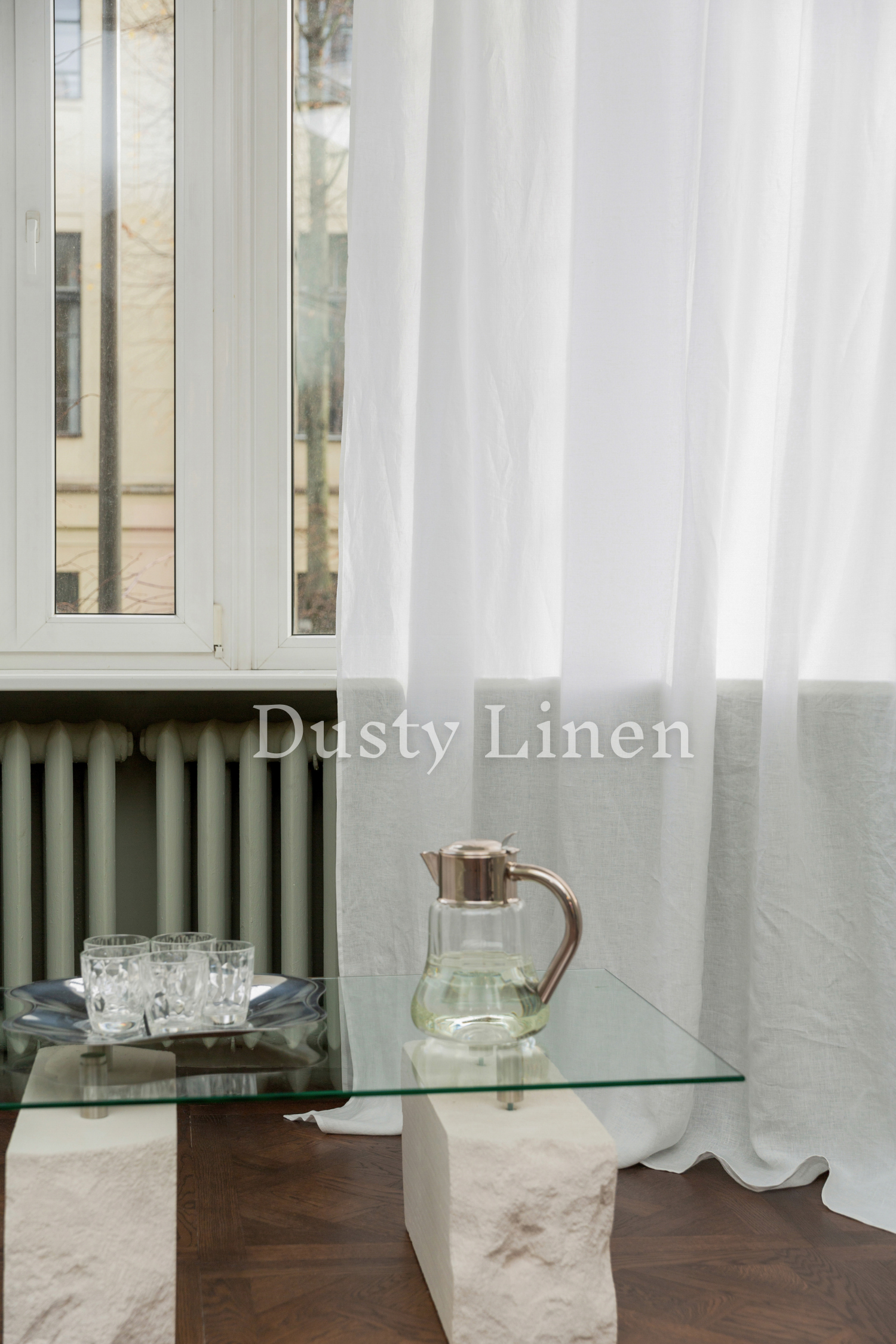 a glass table with a pitcher on top of it